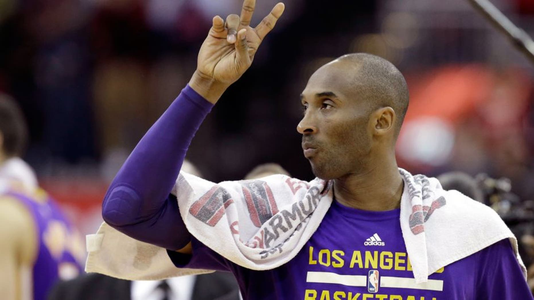 Los Angeles Lakers' Kobe Bryant acknowledges the fans as he leaves the court after an NBA basketball game against the Houston Rockets Saturday, Dec. 12, 2015, in Houston. The Rockets won 126-97. (AP Photo/Pat Sullivan)