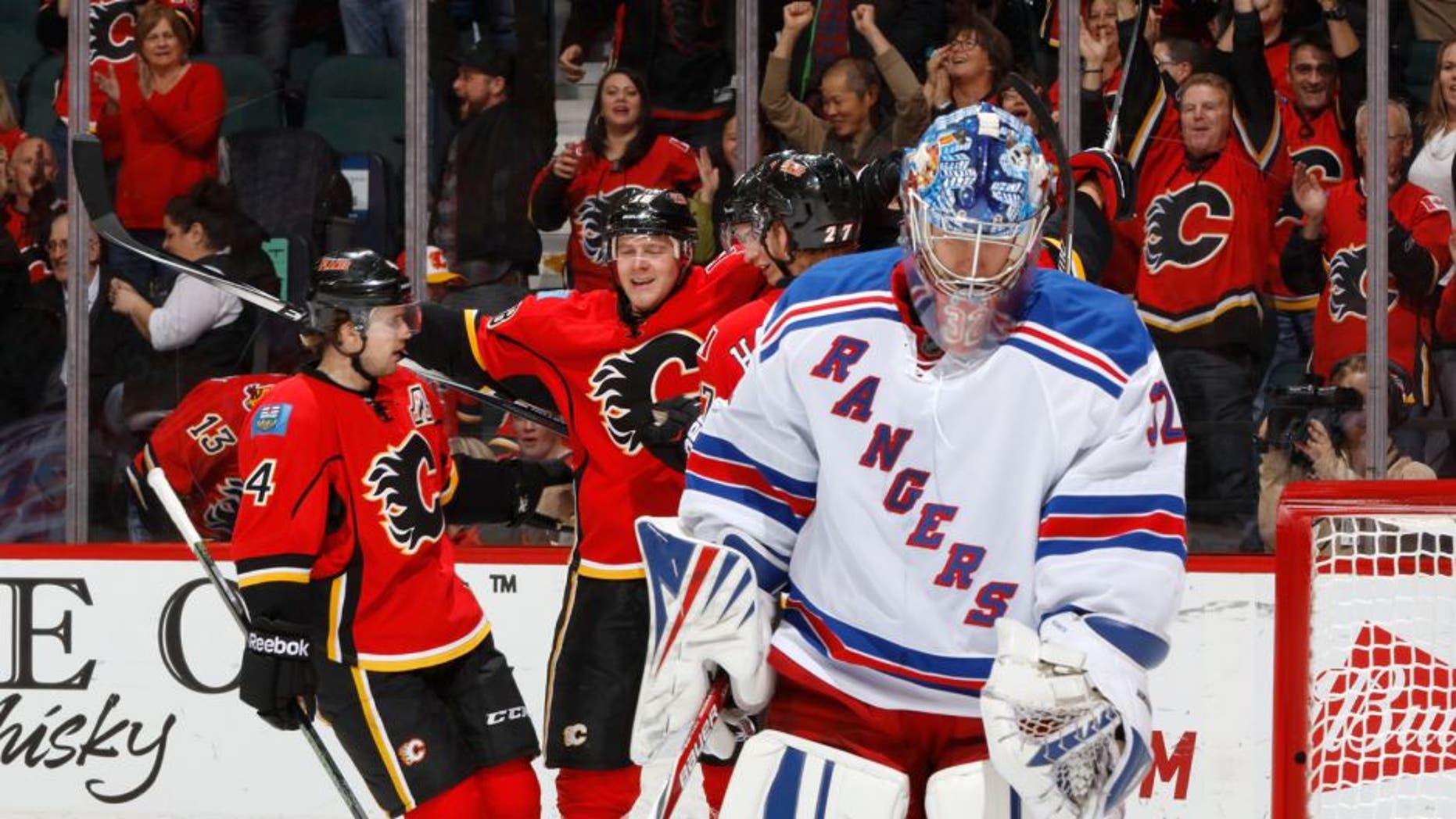 CALGARY, AB - DECEMBER 12: The Calgary Flames celebrate after a goal against the New York Rangers at Scotiabank Saddledome on December 12, 2015 in Calgary, Alberta, Canada. (Photo by Gerry Thomas/NHLI via Getty Images)