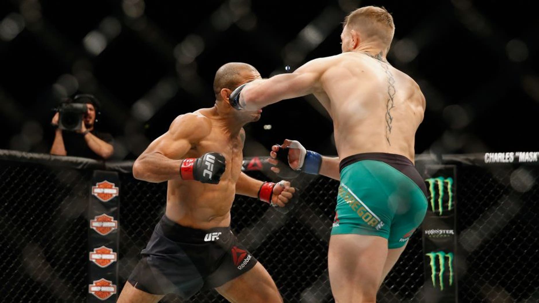 LAS VEGAS, NV - DECEMBER 12: (R-L) Conor McGregor of Ireland punches Jose Aldo of Brazil in their UFC welterweight championship bout during the UFC 194 event inside MGM Grand Garden Arena on December 12, 2015 in Las Vegas, Nevada. (Photo by Christian Petersen/Zuffa LLC/Zuffa LLC via Getty Images)