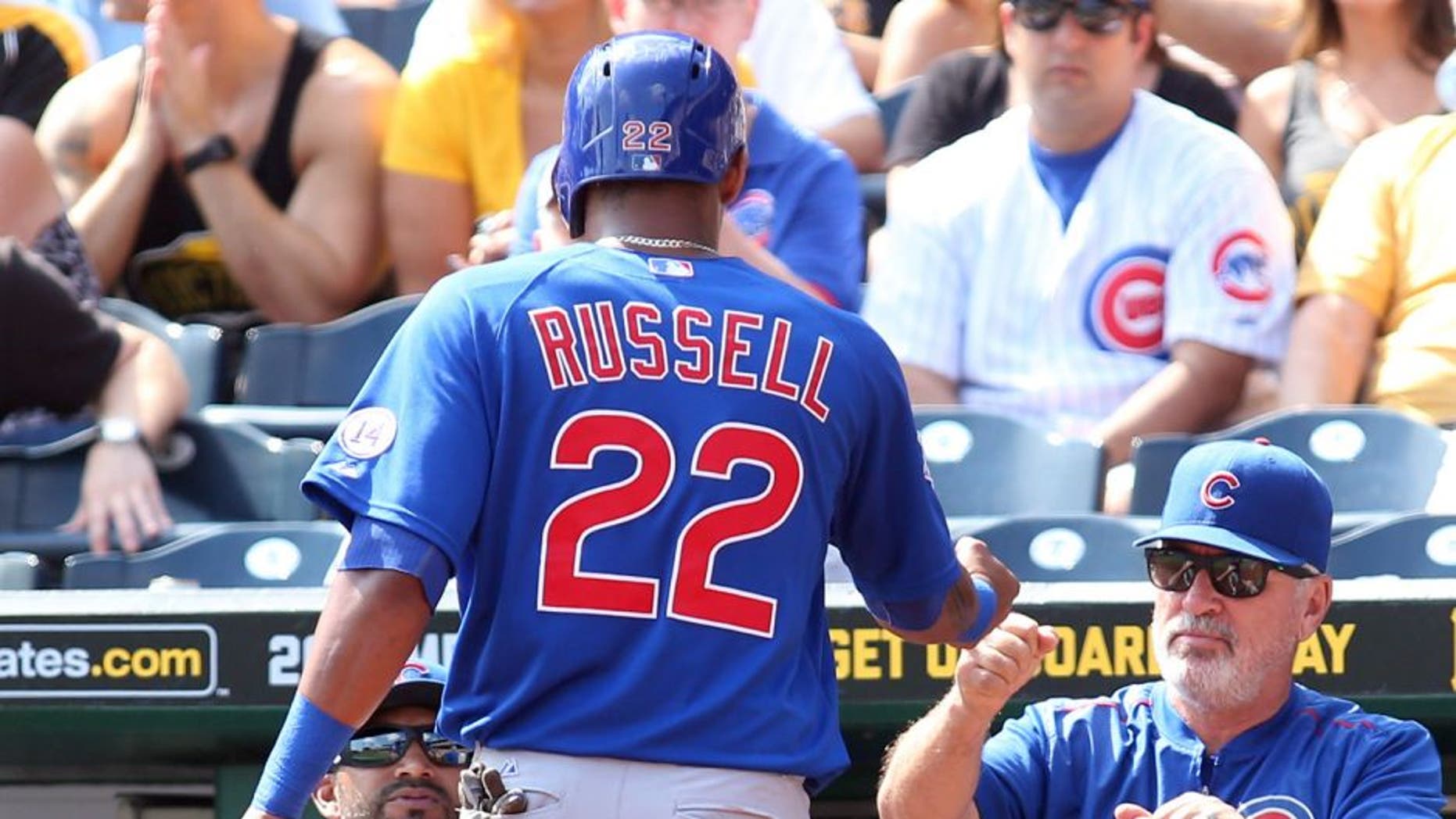 Sep 17, 2015; Pittsburgh, PA, USA; Chicago Cubs manager Joe Maddon (R) greets shortstop Addison Russell (22) after Russell scored a run against the Pittsburgh Pirates during the second inning at PNC Park. Mandatory Credit: Charles LeClaire-USA TODAY Sports