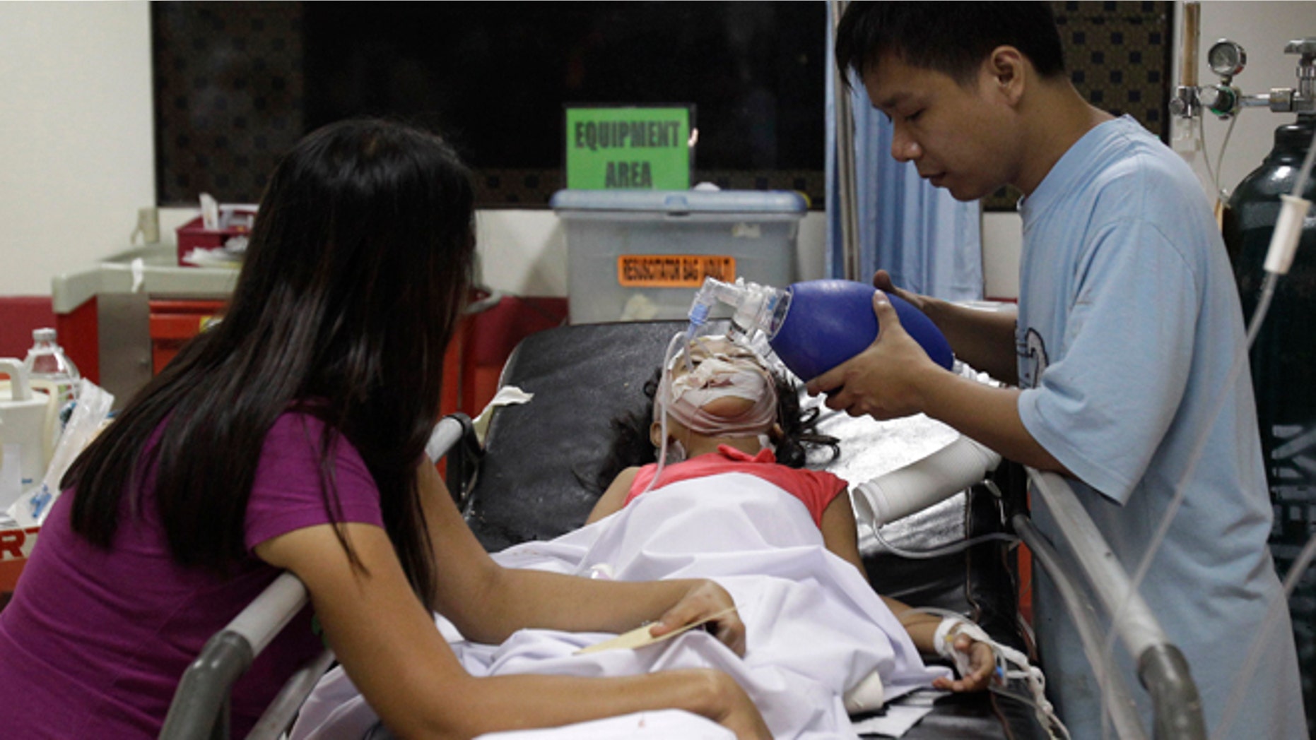 Jan. 1, 2013: Seven-year-old Stephanie Nicole Ella lays in a bed as her parents aid in giving her life support while being treated at the East Avenue Medical Center after she was hit in the head by a stray bullet while watching fireworks with her family during New Year's Eve revelry, in suburban Quezon city, north of Manila, Philippines. Ella died in a hospital Wednesday heightening calls to halt one of Asia's most violent celebrations of the new year.