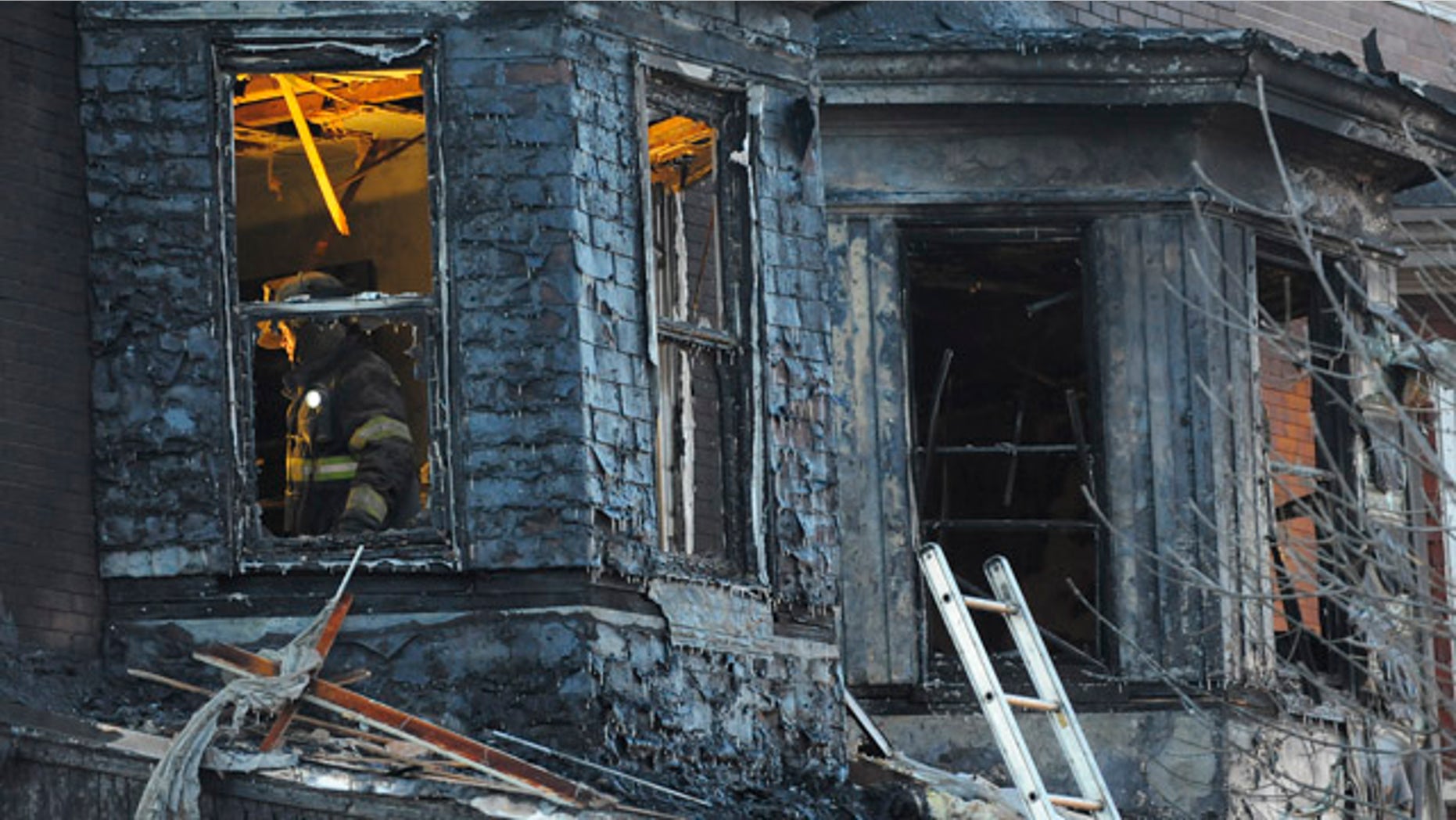 Dec. 14: Firefighters investigate the scene of an early morning two-alarm fire in the 2300 block of Homewood Ave. in East Baltimore.