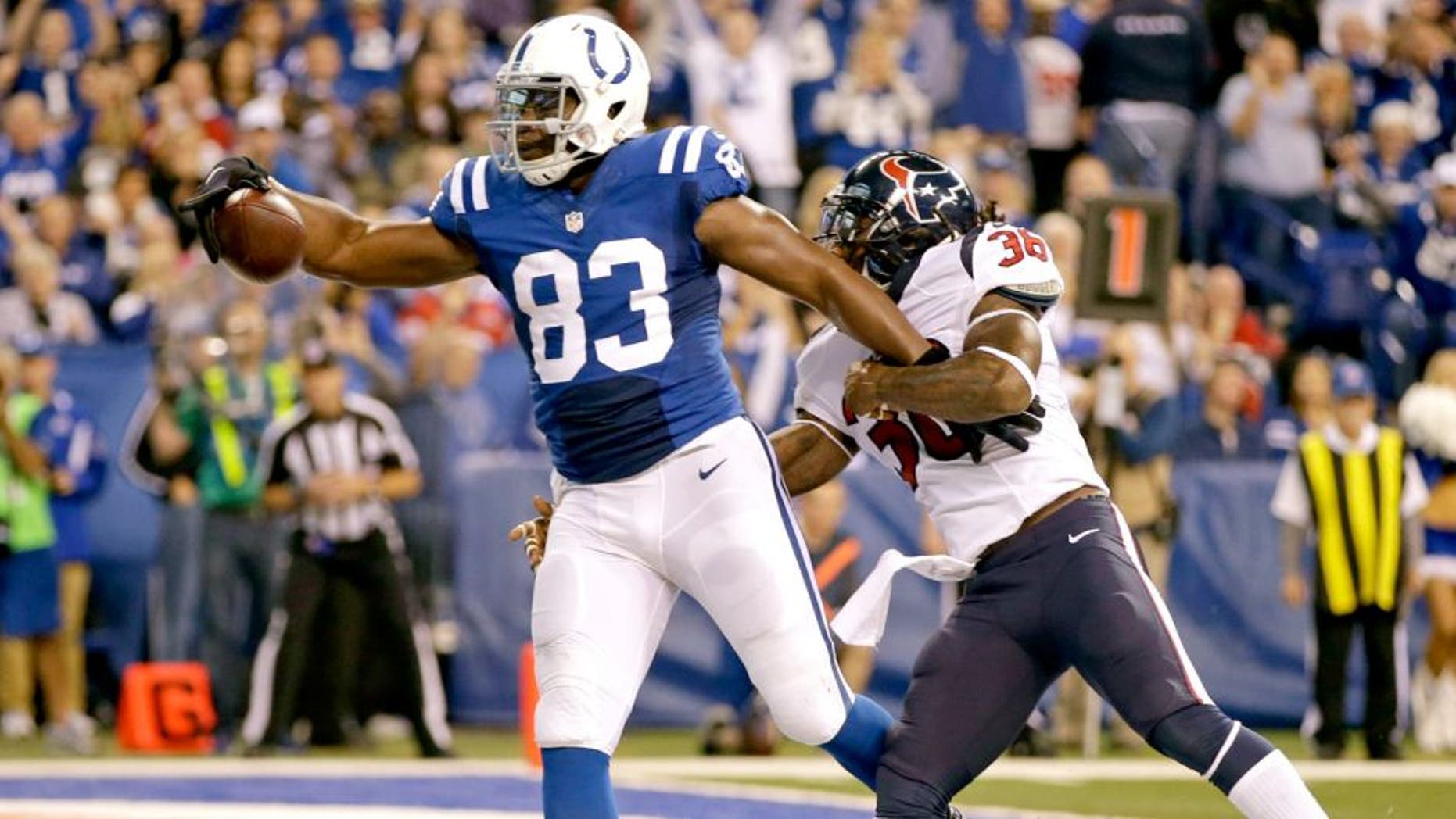 Indianapolis Colts tight end Dwayne Allen, left, catches a pass for a touchdown in front of Houston Texans strong safety D.J. Swearinger during the first half of an NFL football game in Indianapolis, Sunday, Dec. 14, 2014. (AP Photo/Darron Cummings)