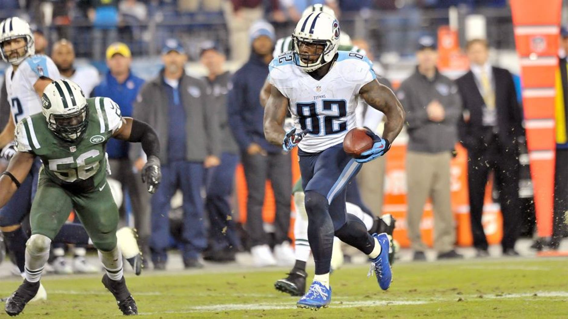 Dec 14, 2014; Nashville, TN, USA; Tennessee Titans tight end Delanie Walker (82) rushes against New York Jets inside linebacker Demario Davis (56) in the final second of the game during the second half at LP Field. Jets won 16-11. Mandatory Credit: Jim Brown-USA TODAY Sports