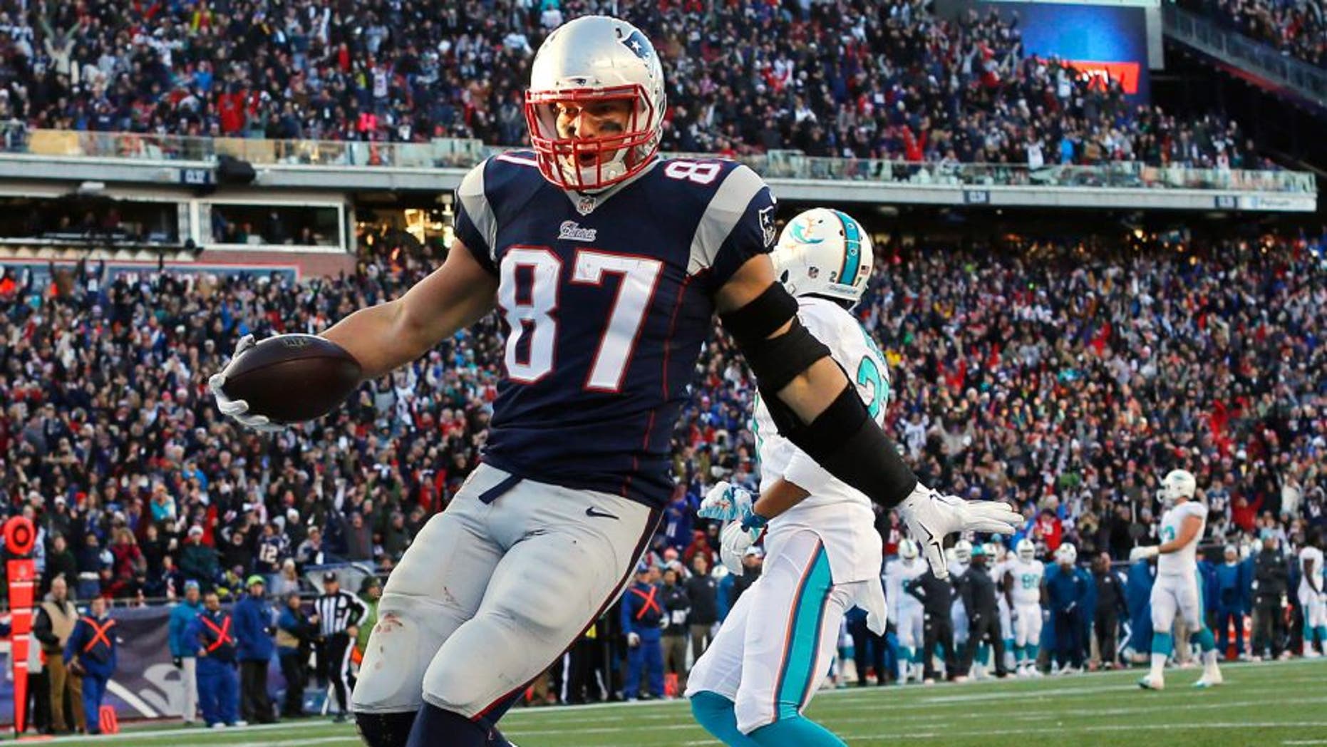 Dec 14, 2014; Foxborough, MA, USA; New England Patriots tight end Rob Gronkowski (87) scores a touchdown during the second half against the Miami Dolphins at Gillette Stadium. The Patriots won 41-13. Mandatory Credit: Winslow Townson-USA TODAY Sports