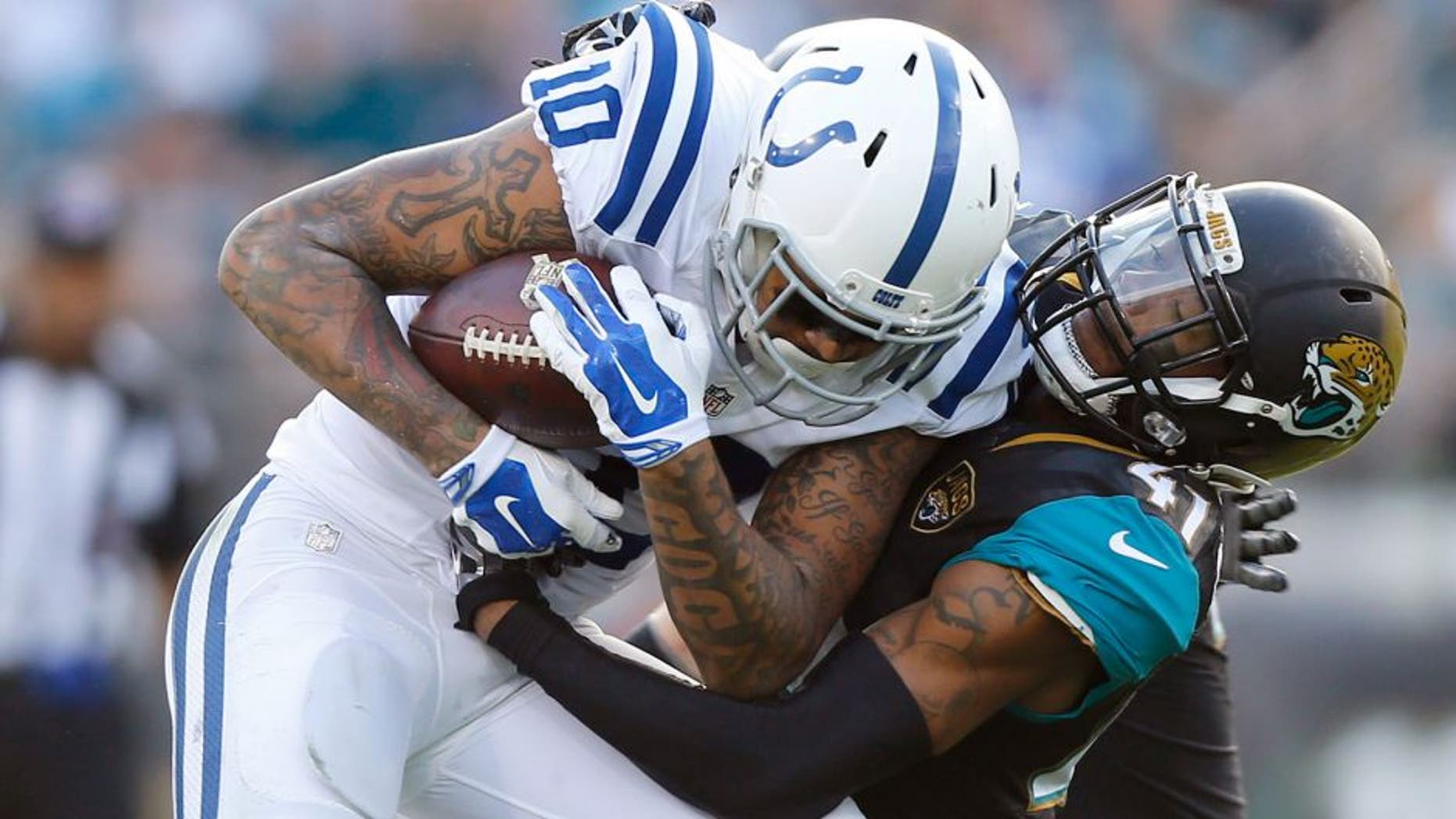 Dec 13, 2015; Jacksonville, FL, USA; Jacksonville Jaguars cornerback Nick Marshall (41) tackles Indianapolis Colts wide receiver Donte Moncrief (10) in the fourth quarter at EverBank Field. The Jaguars won 51-16. Mandatory Credit: Jim Steve-USA TODAY Sports