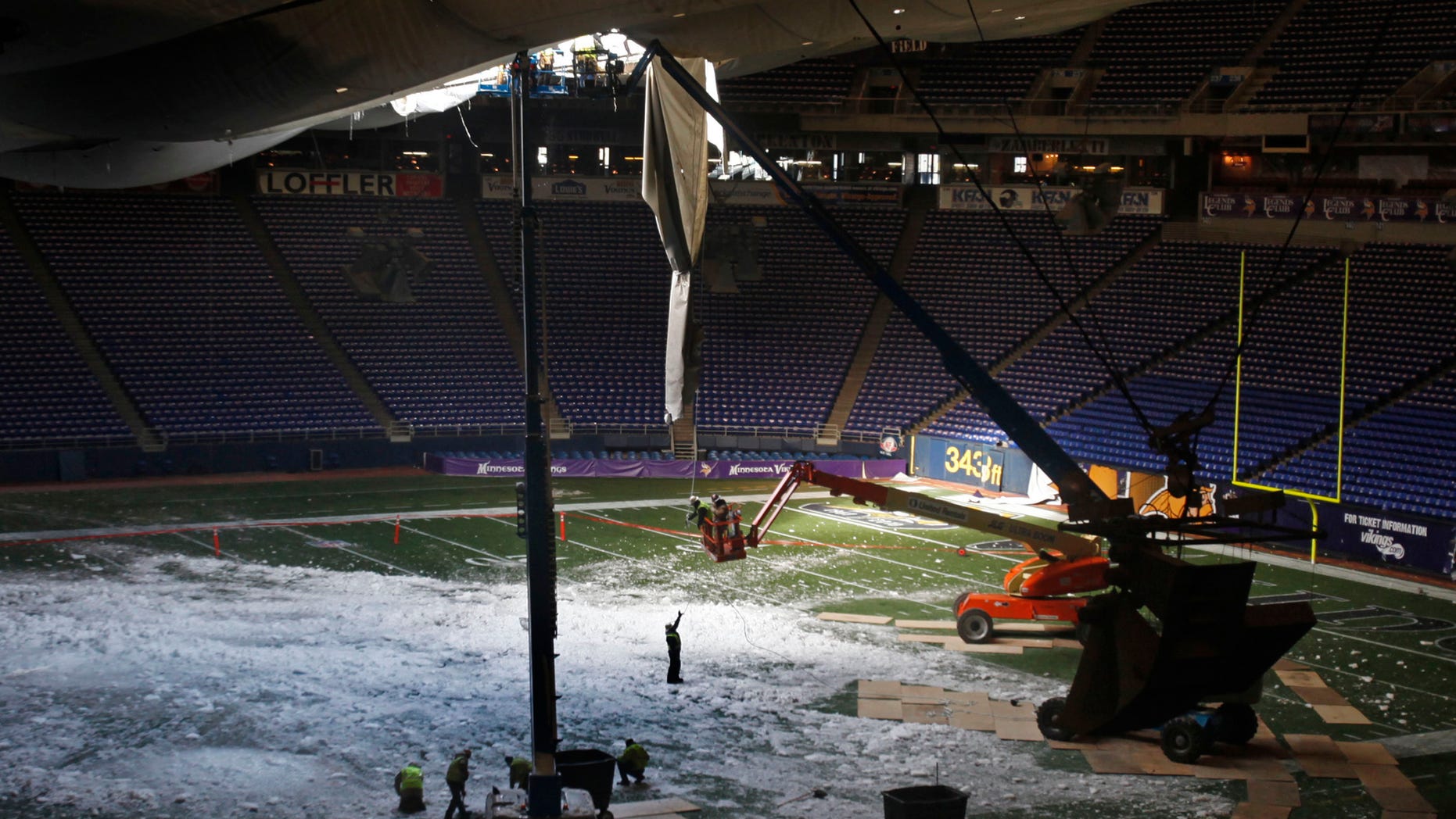 Dec. 14: Workers tend to the torn roof of the Metrodome in Minneapolis.
