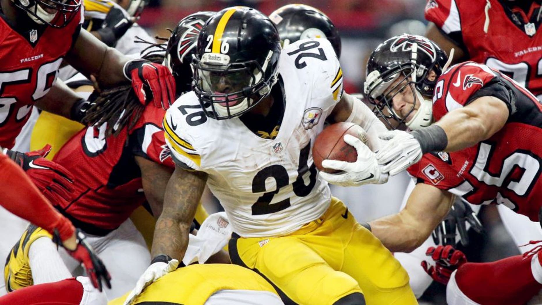 Dec 14, 2014; Atlanta, GA, USA; Pittsburgh Steelers running back Le'Veon Bell (26) fights for extra yards against Atlanta Falcons inside linebacker Paul Worrilow (55) and others in the fourth quarter of their game at the Georgia Dome. The Steelers won 27-20. Mandatory Credit: Jason Getz-USA TODAY Sports