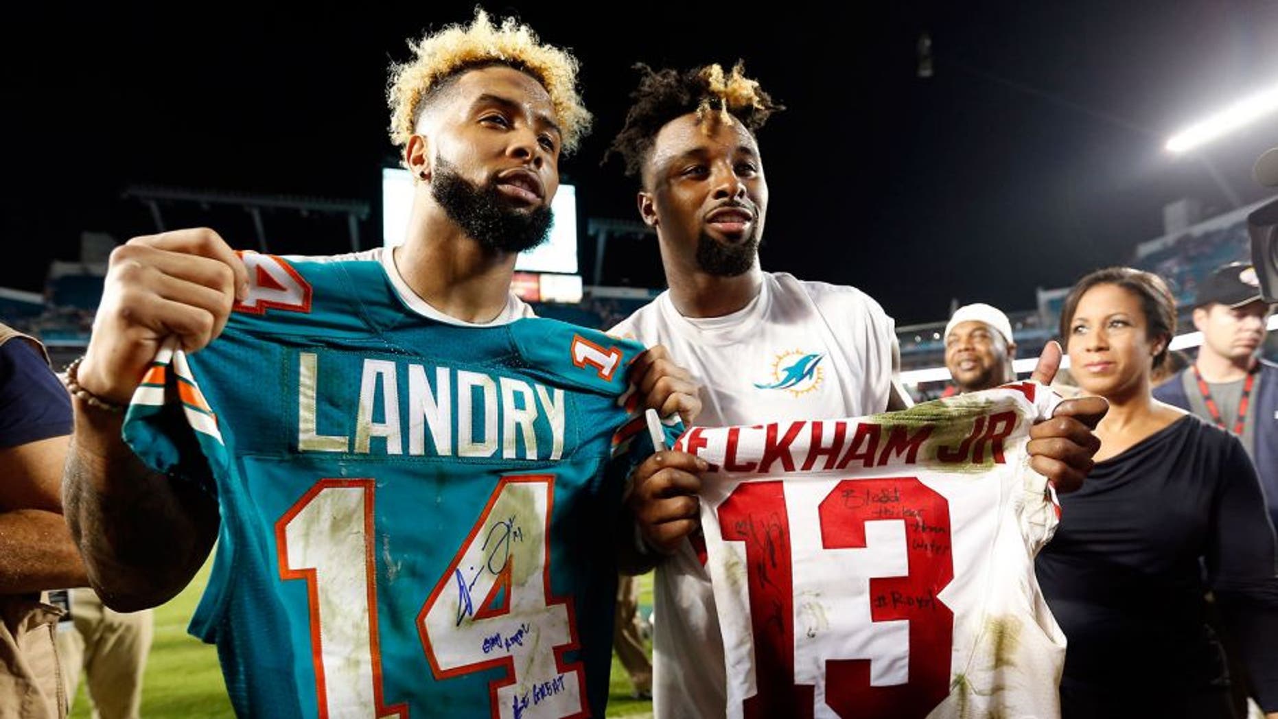 Dec 14, 2015; Miami Gardens, FL, USA; Miami Dolphins wide receiver Jarvis Landry (14) and New York Giants wide receiver Odell Beckham Jr. (13) both display their signed jersey's after their game at Sun Life Stadium. Mandatory Credit: Steve Mitchell-USA TODAY Sports