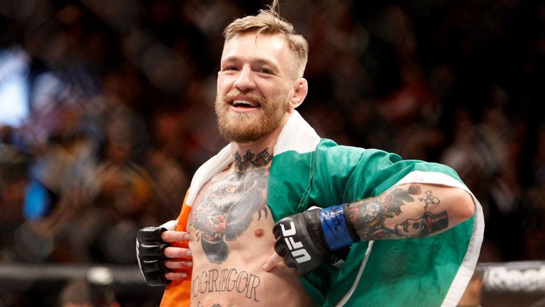 LAS VEGAS, NV - DECEMBER 12: Conor McGregor celebrates after a first-round knockout victory over Jose Aldo in their featherweight title fight during UFC 194 on December 12, 2015 in Las Vegas, Nevada. (Photo by Steve Marcus/Getty Images)