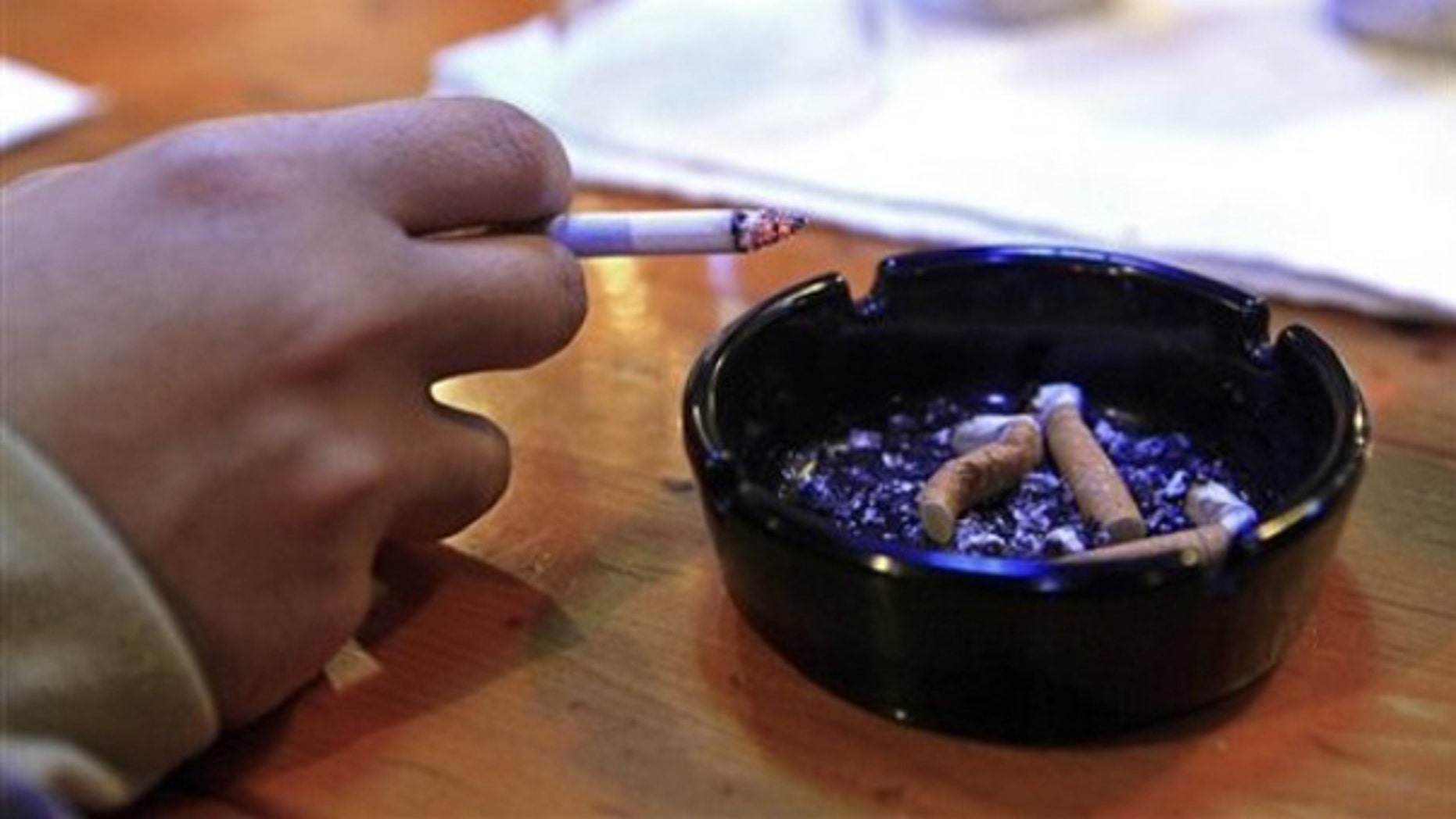 FILE: 2009: A smoker at the Satisfaction Restaurant & Bar in Durham, N.C.