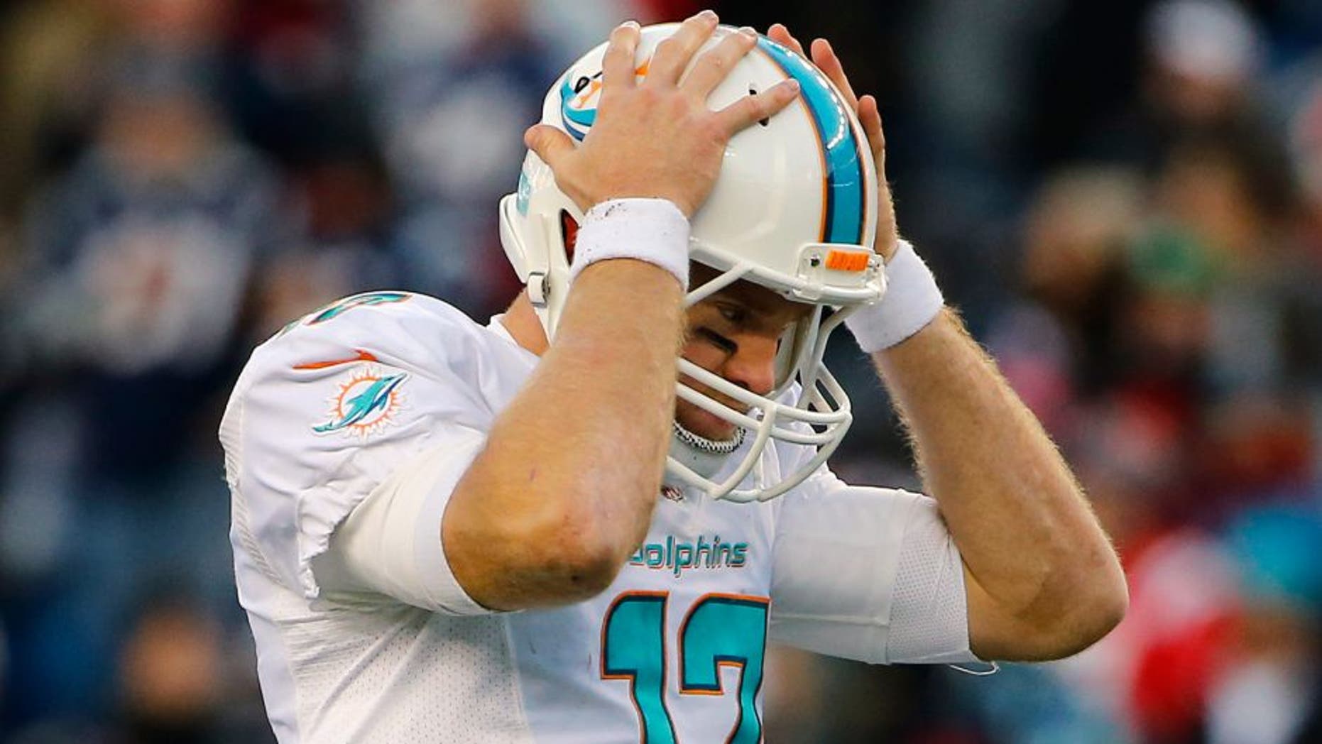 Dec 14, 2014; Foxborough, MA, USA; Miami Dolphins quarterback Ryan Tannehill (17) reacts to a missed pass during the second half against the New England Patriots at Gillette Stadium. The Patriots won 41-13. Mandatory Credit: Winslow Townson-USA TODAY Sports