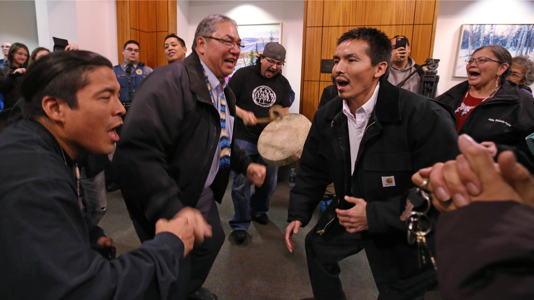 Dec. 17, 2015: Marvin Roberts, right, and Tanana Chiefs Conference President Victor Joseph, left, dance with friends and family at the Rabinowitz Courthouse in Fairbanks, Alaska.