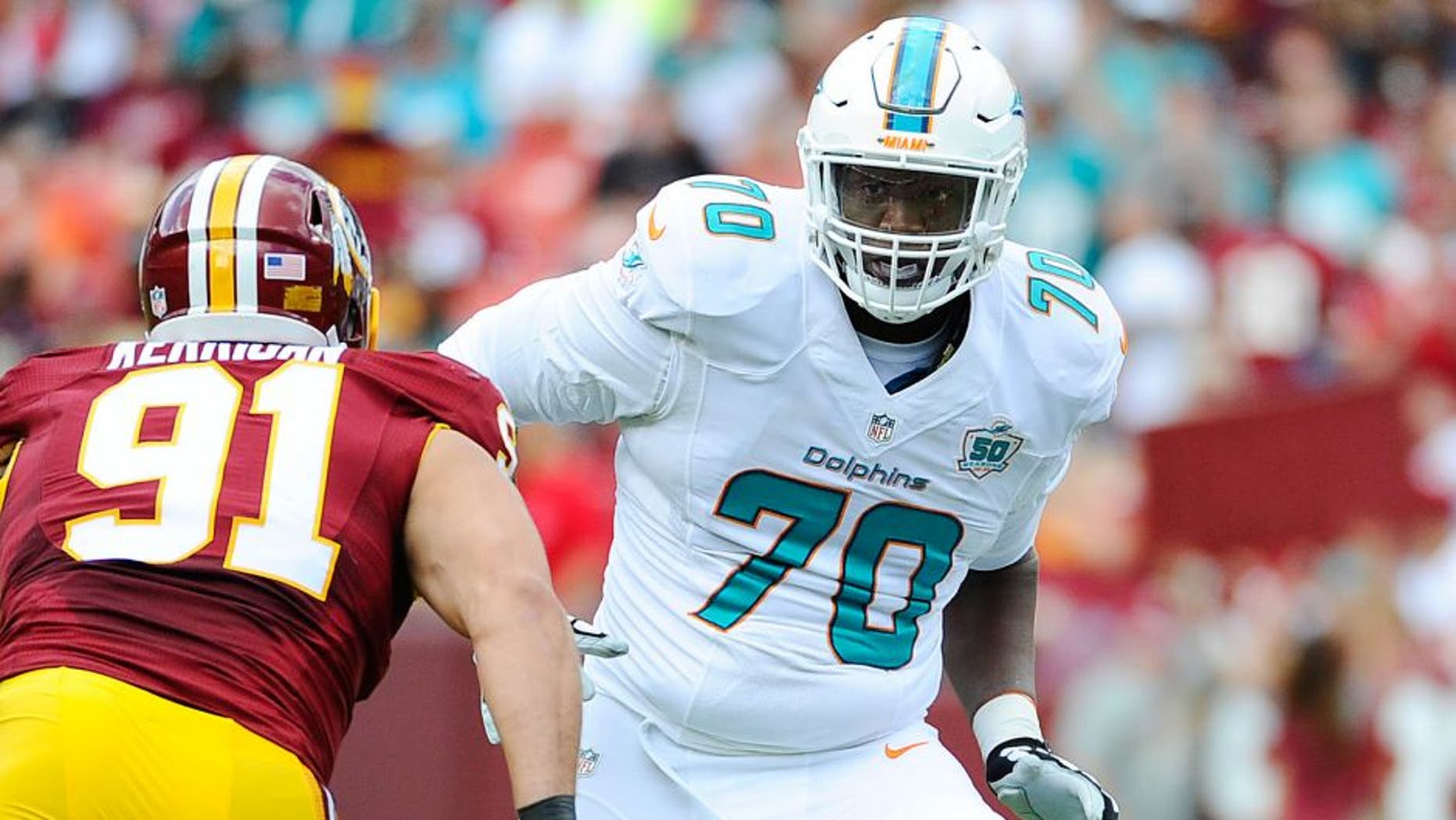 Sep 13, 2015; Landover, MD, USA; Miami Dolphins tackle Ja'Wuan James (70) prepares to block Washington Redskins outside linebacker Ryan Kerrigan (91) during the first half at FedEx Field. Mandatory Credit: Brad Mills-USA TODAY Sports