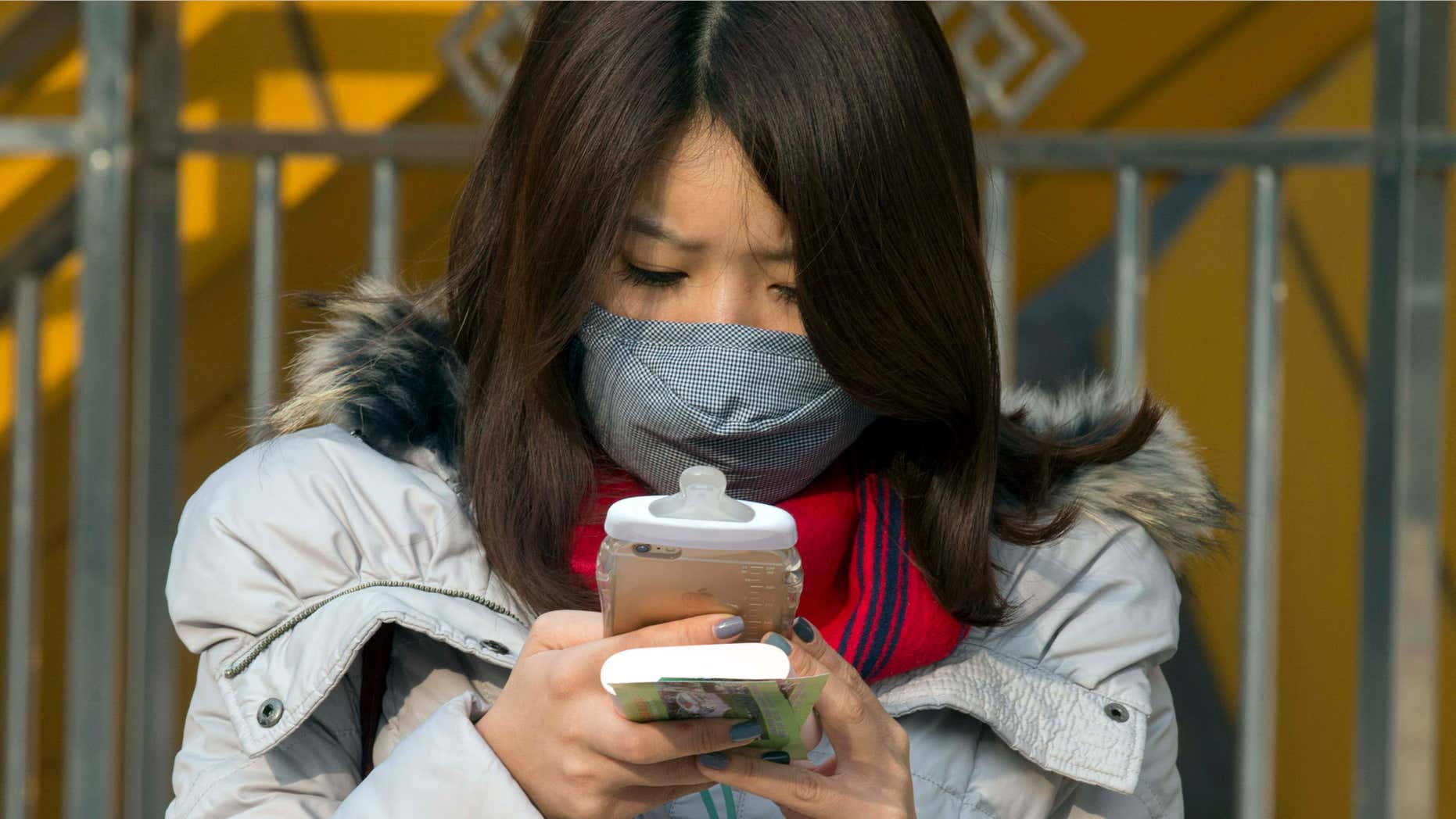 Dec. 19, 2015: A woman wears a mask during a polluted day in Beijing, China.