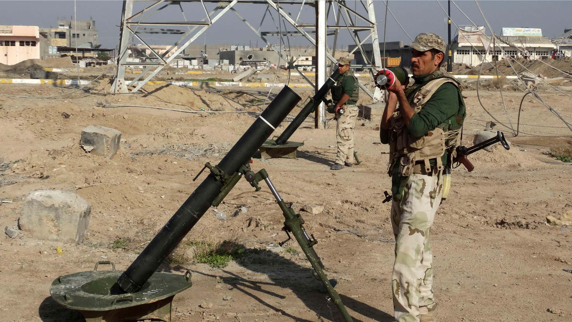 Nov. 30, 2015: Iraqi soldiers prepare to shell Islamic State group positions at the front-line as Iraqi army and allied Sunni volunteer tribal fighters supported by U.S.-led coalition airstrikes are tightened the siege of Ramadi, the capital of Iraq's Anbar province, 70 miles west of Baghdad, Iraq