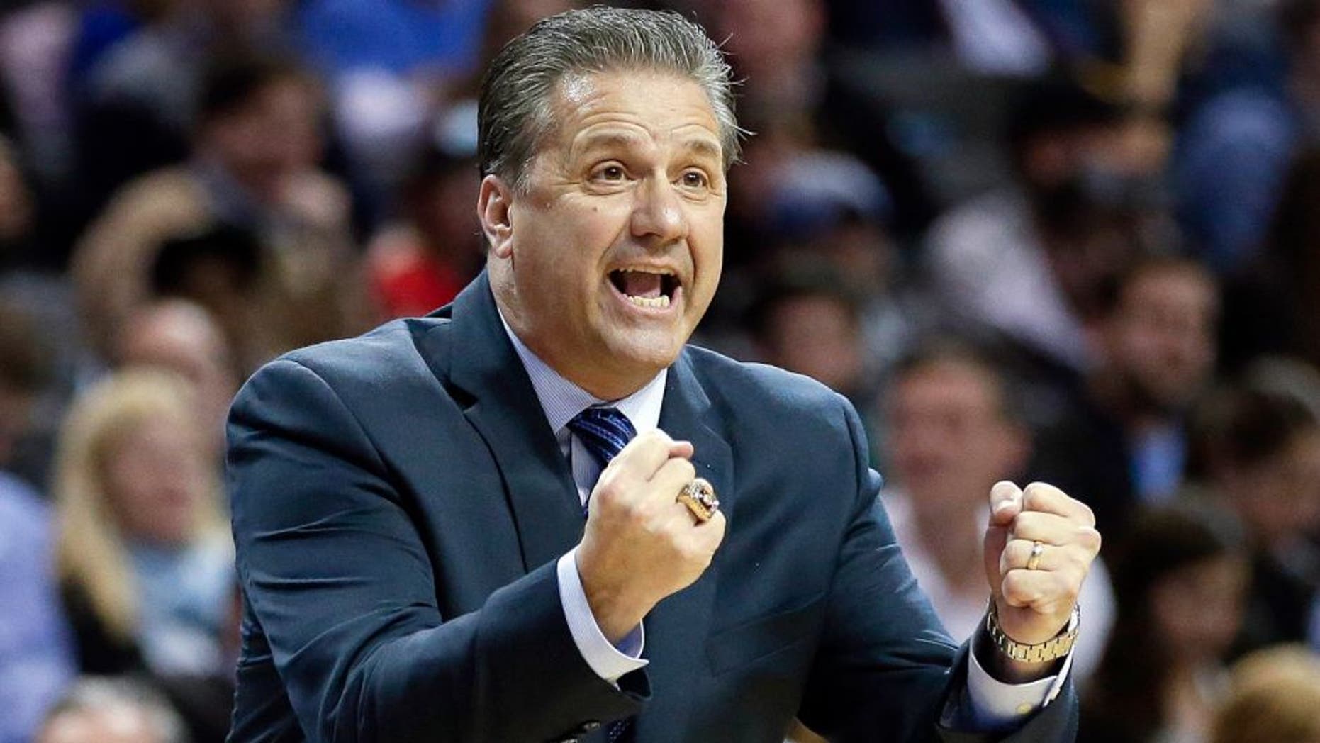 Kentucky head coach John Calipari calls out to his team during the first half of an NCAA college basketball game against Ohio State Saturday, Dec. 19, 2015, in New York. (AP Photo/Frank Franklin II)