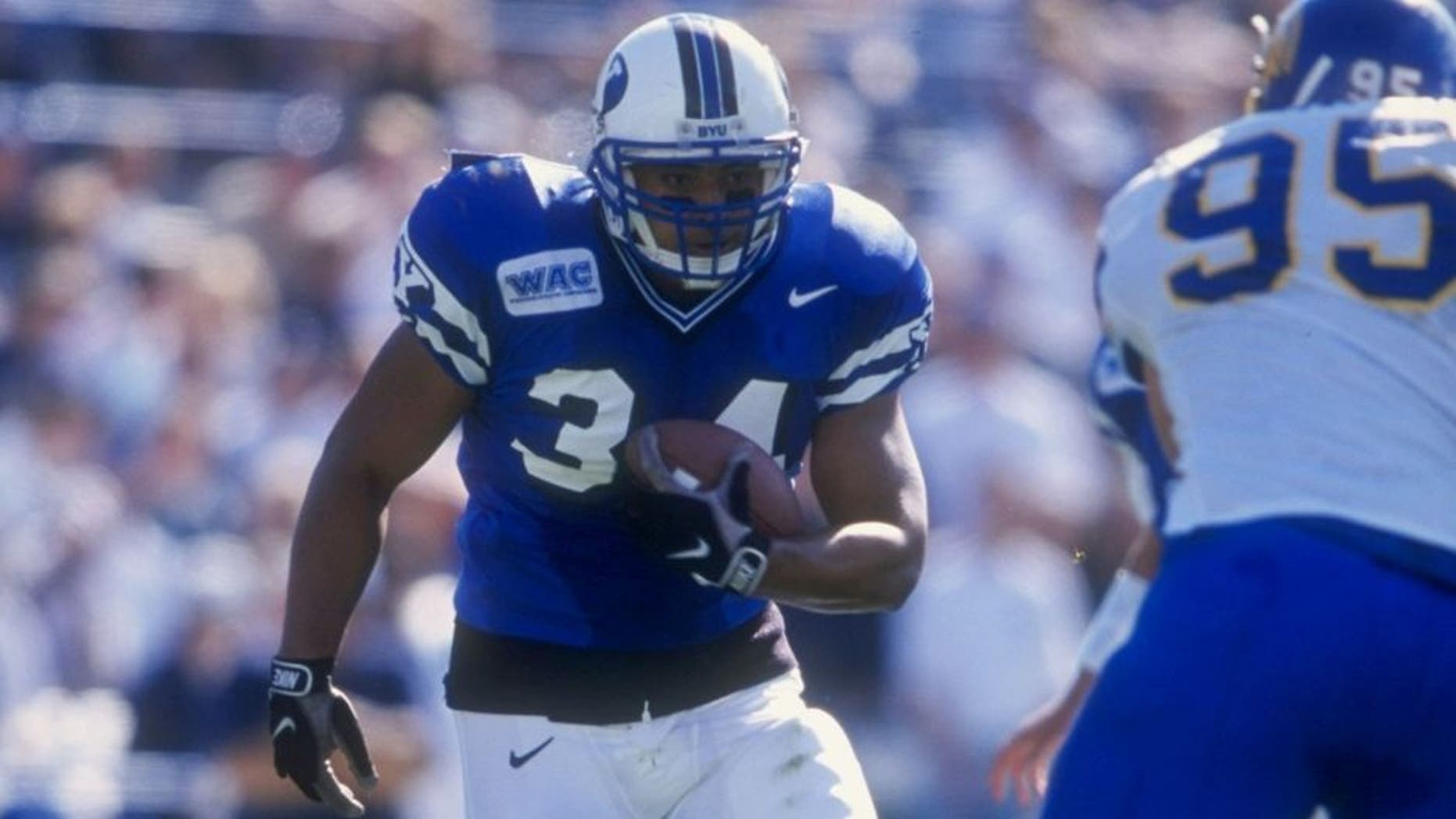 24 Oct 1998: Kalani Sitake #34 of the Bringham Young University Cougars runs with the ball during the game against the San Jose State Spartans at Cougar Stadium in Provo, Utah. BYU defeated San Jose 46-43. Mandatory Credit: Todd Warshaw /Allsport