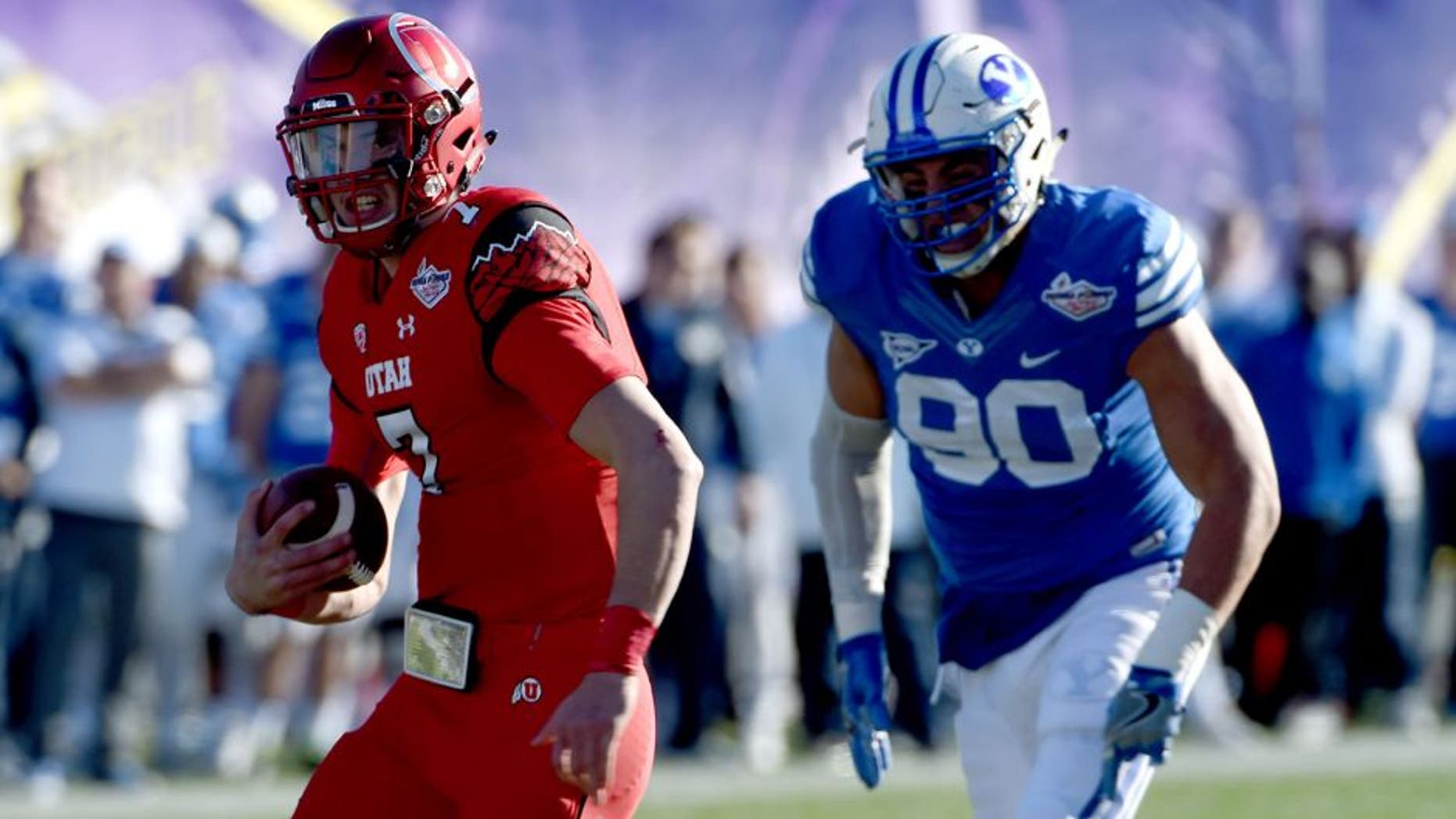 Dec 19, 2015; Las Vegas, NV, USA; Utah Utes quarterback Travis Wilson (7) rushes up the middle as the Utes face off against BYU in the Las Vegas Bowl at Sam Boyd Stadium. Mandatory Credit: Stephen R. Sylvanie-USA TODAY Sports