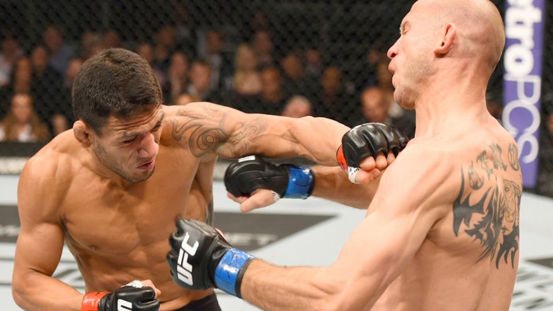 Rafael dos Anjos punches Donald Cerrone in their UFC lightweight title bout during the UFC Fight Night event at the Amway Center on December 19, 2015 in Orlando, Florida. (Photo by Josh Hedges/Zuffa LLC/Zuffa LLC via Getty Images)