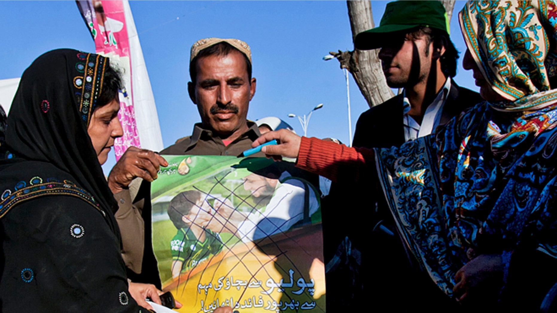 Dec. 19, 2012: Pakistani polio workers cross out an anti-polio campaign poster during a demonstration against the killing of their colleagues, in Islamabad, Pakistan.