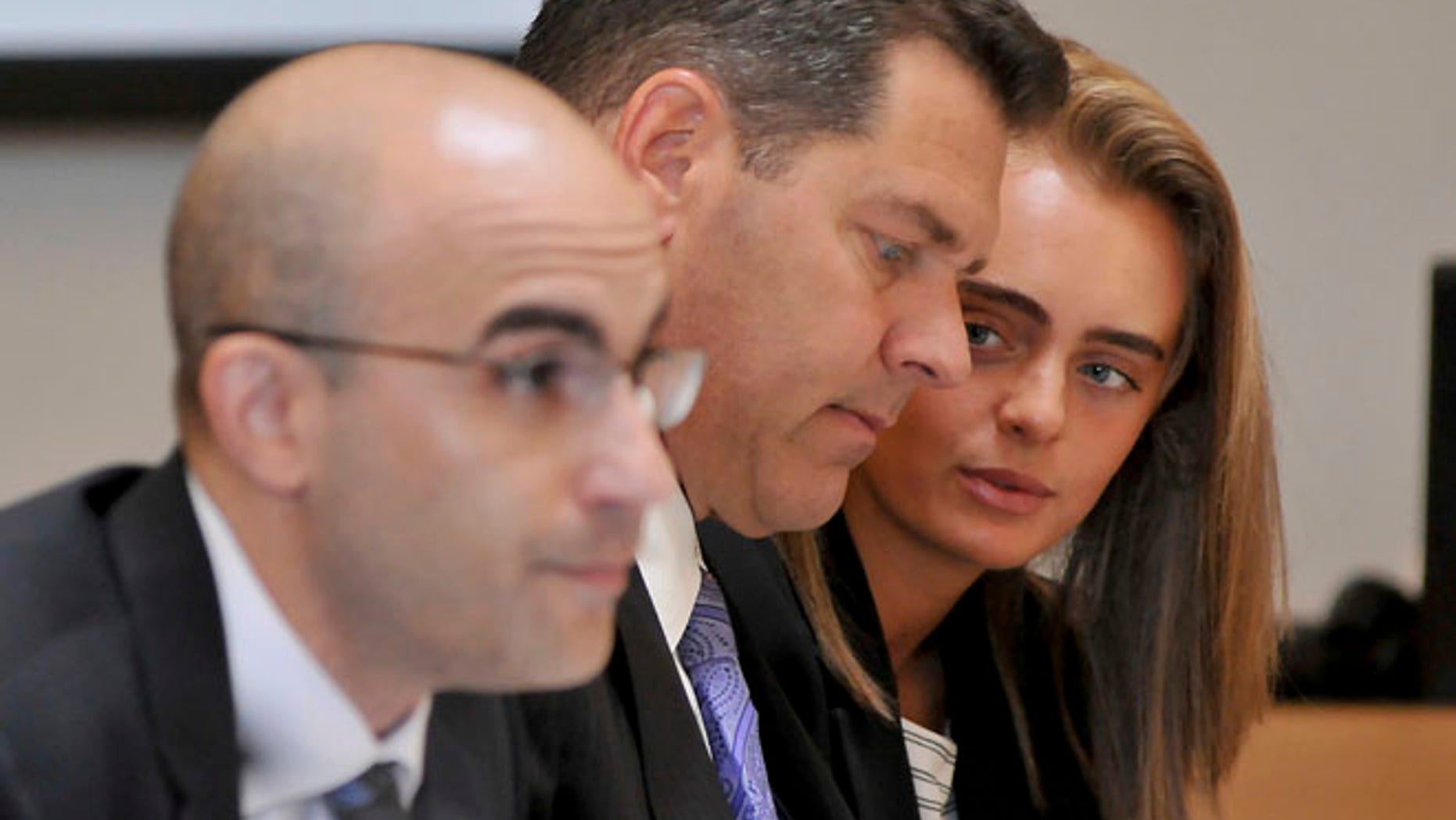 June 16: Defendant Michelle Carter, right, confers with her lawyer Joe Cataldo, center, as second defense attorney Cory Madera listens to testimonies.