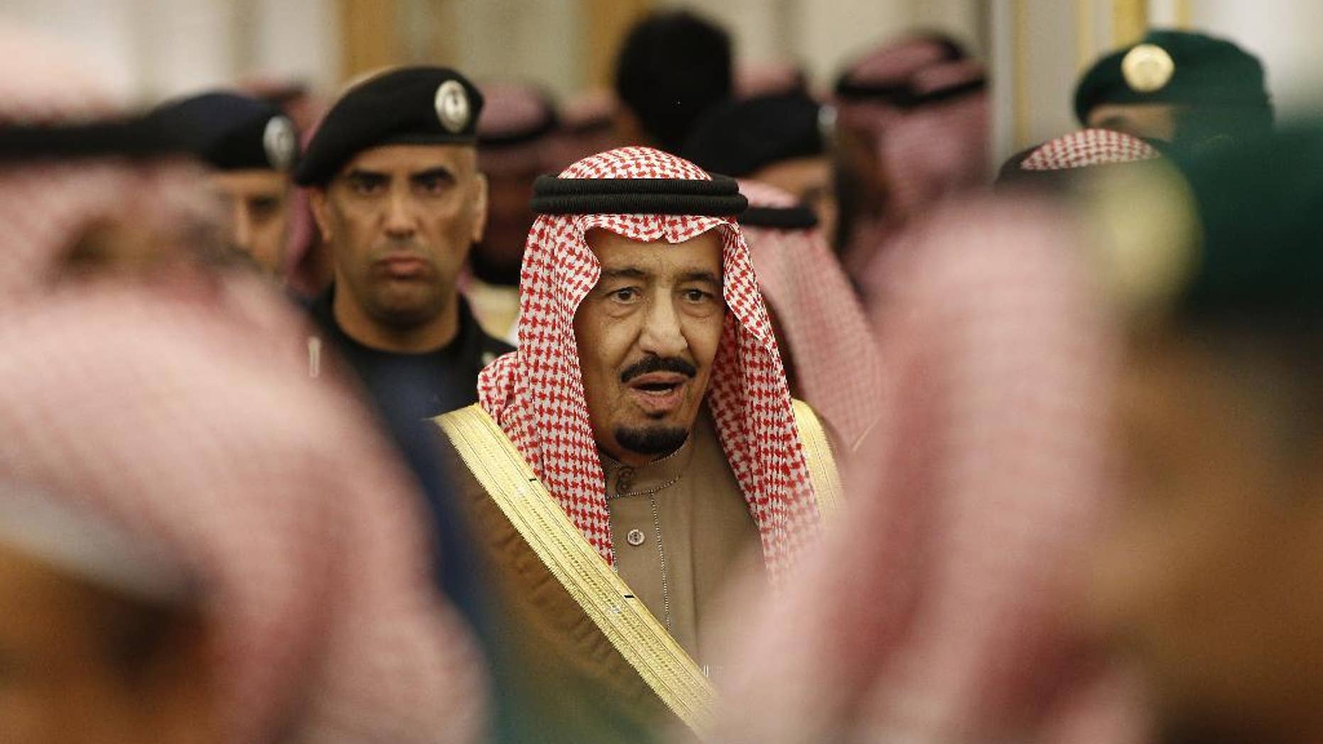 FILE - In this Jan. 24, 2015 file photo, Saudi Arabia's King Salman attends a ceremony at the Diwan royal palace in Riyadh. Saudi Arabia's King Salman is reducing the salaries and benefits of senior government officials as lower oil prices continue to pinch the kingdom's economy, but a separate decision also cuts bonuses for public sector employees. (AP Photo/Yoan Valat, Pool, File)