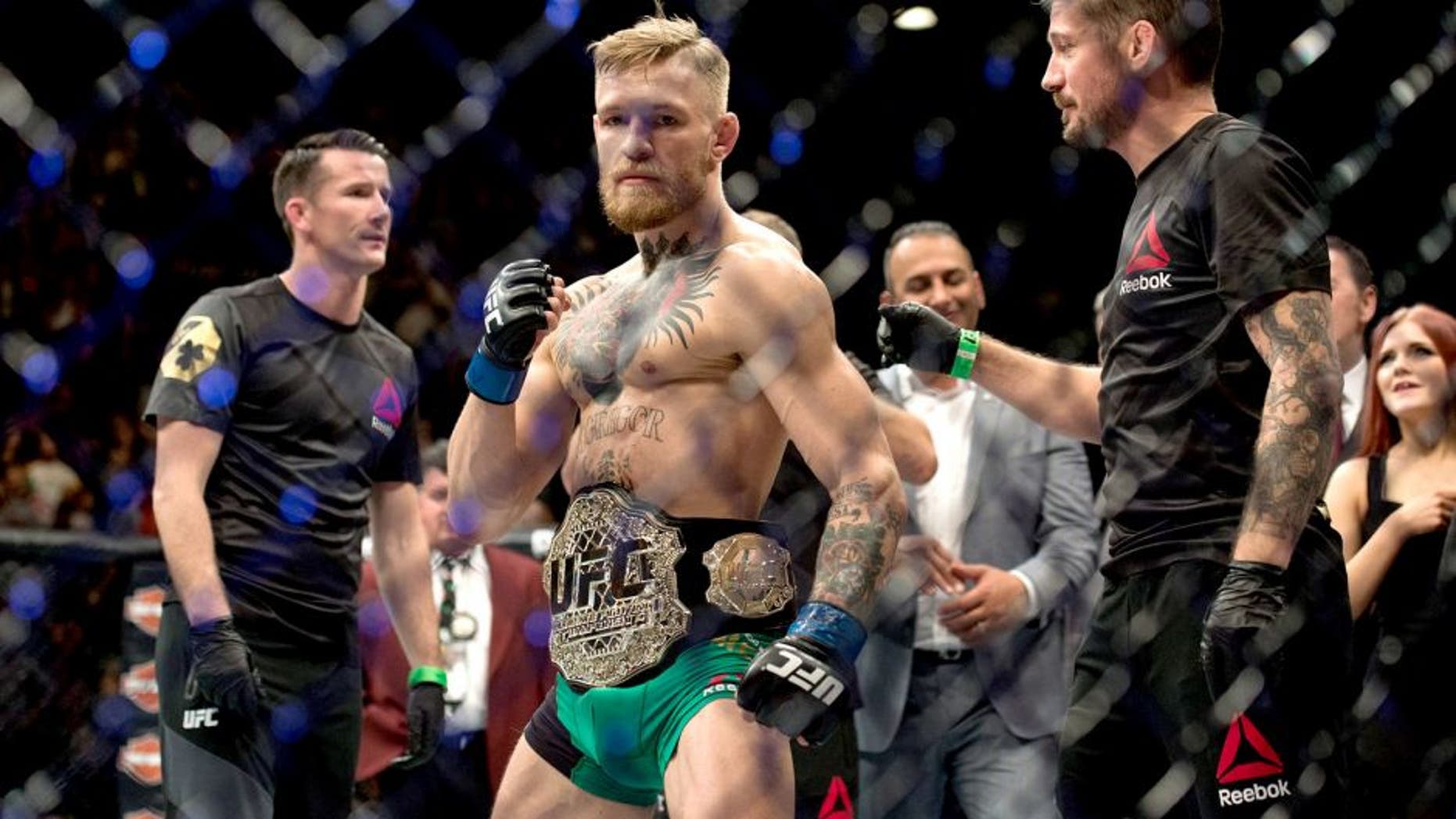 LAS VEGAS, NV - DECEMBER 12: UFC featherweight champion Conor McGregor celebrates his 13 second knockout victory over Jose Aldo in their featherweight championship fight during the UFC 194 event inside MGM Grand Garden Arena on December 12, 2015 in Las Vegas, Nevada. (Photo by Brandon Magnus/Zuffa LLC/Zuffa LLC via Getty Images)