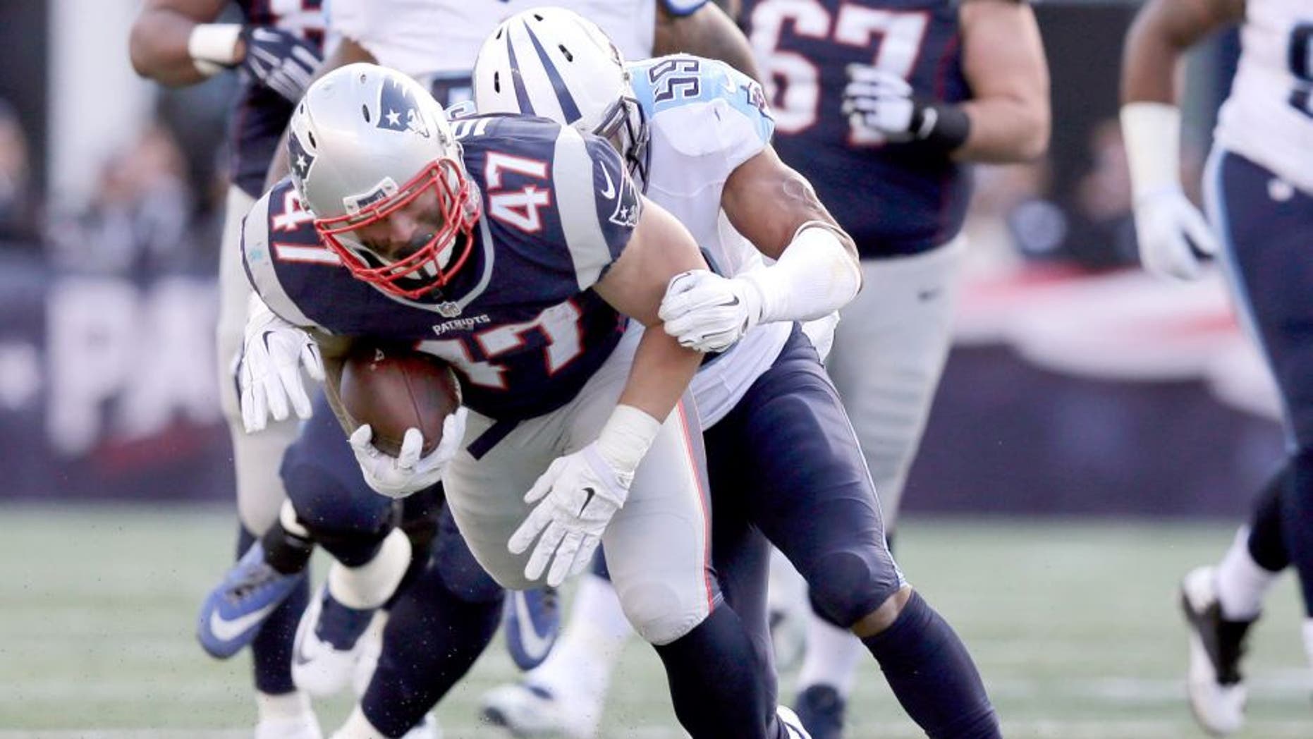Tennessee Titans linebacker Wesley Woodyard (59) tackles New England Patriots running back Joey Iosefa (47) in the first half of an NFL football game, Sunday, Dec. 20, 2015, in Foxborough, Mass. (AP Photo/Charles Krupa)