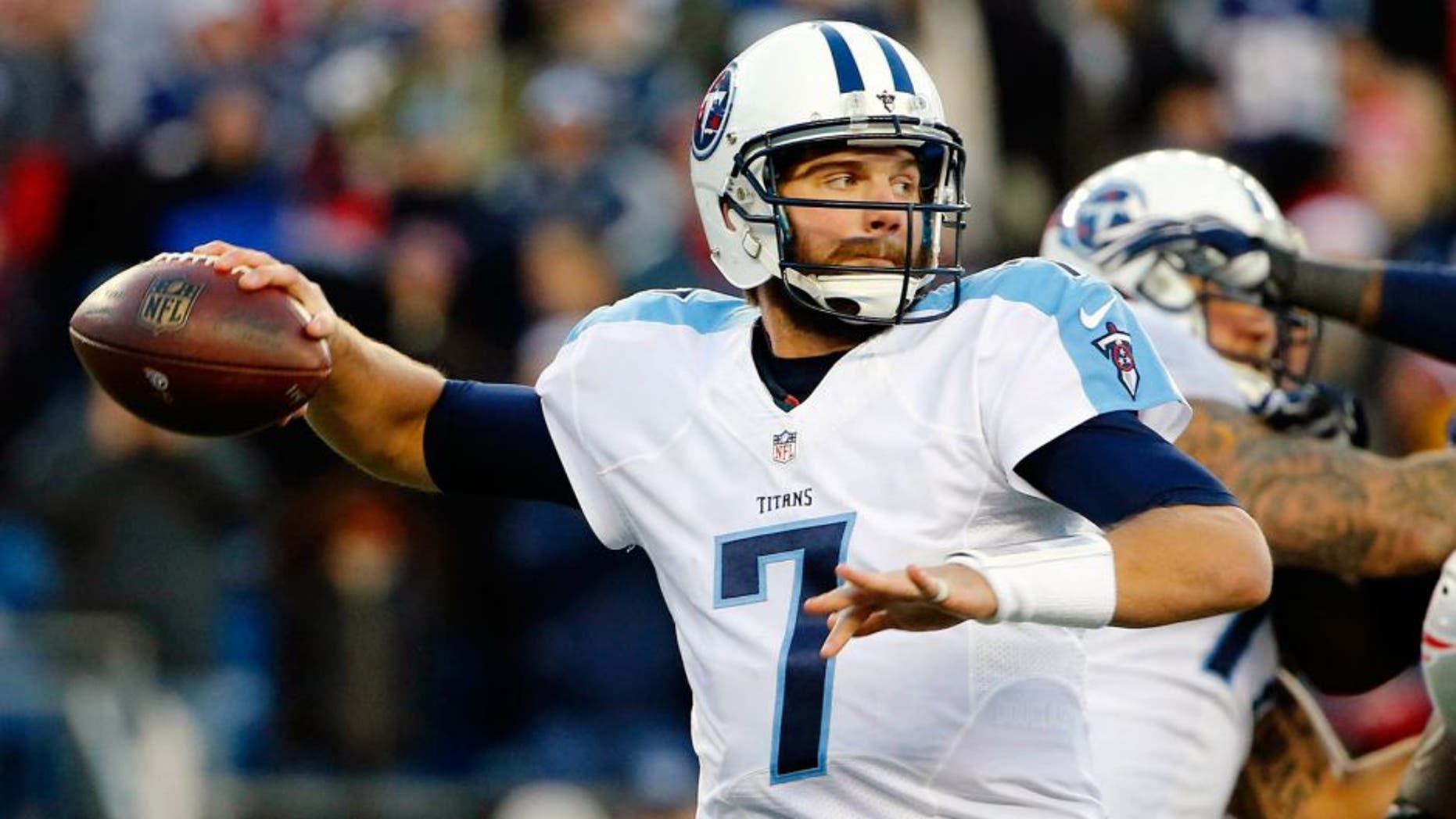 Dec 20, 2015; Foxborough, MA, USA; Tennessee Titans quarterback Zach Mettenberger (7) throws under pressure during the second half of the New England Patriots 33-16 win over the Tennessee Titans at Gillette Stadium. Mandatory Credit: Winslow Townson-USA TODAY Sports