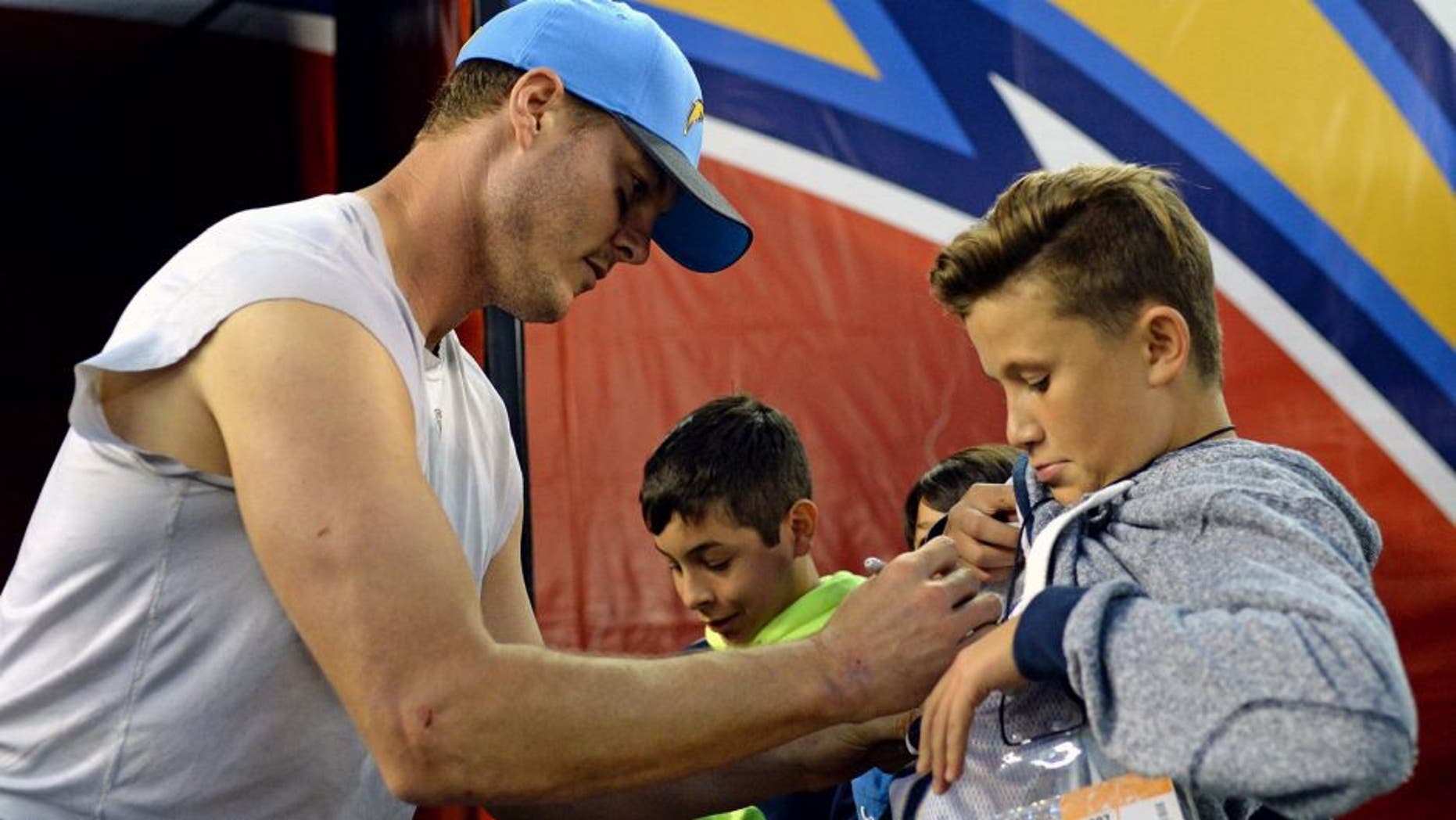 Dec 20, 2015; San Diego, CA, USA; San Diego Chargers quarterback Philip Rivers (17) signs autographs for fans after the Chargers beat the Miami Dolphins 30-14 at Qualcomm Stadium. Mandatory Credit: Jake Roth-USA TODAY Sports
