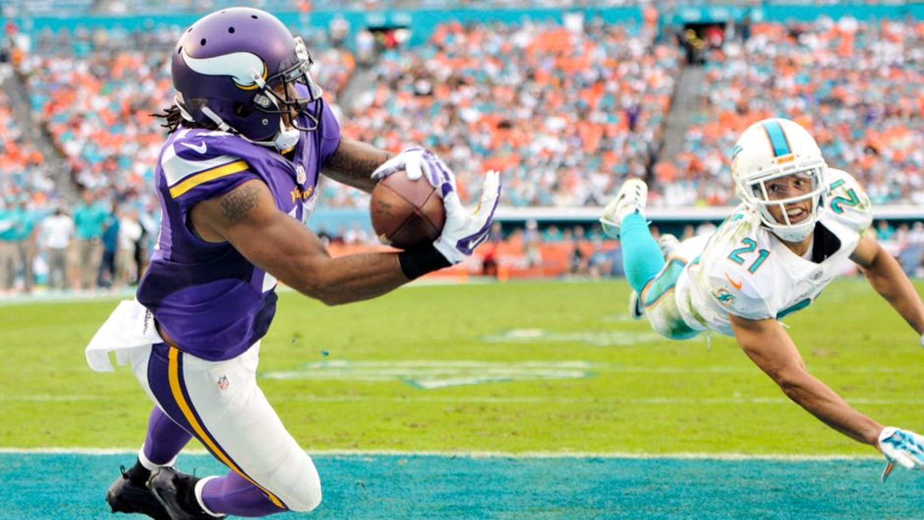 Dec 21, 2014; Miami Gardens, FL, USA; Minnesota Vikings wide receiver Jarius Wright (17) makes the diving touchdown catch as Miami Dolphins cornerback Brent Grimes (21) defends in the second half of the game at Sun Life Stadium. Mandatory Credit: Brad Barr-USA TODAY Sports