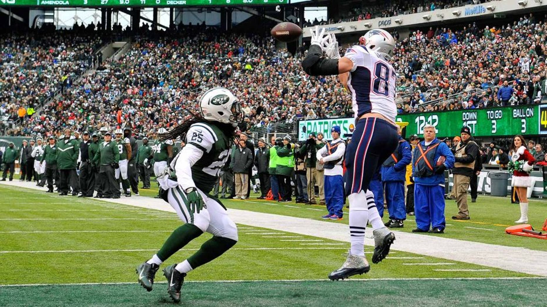 EAST RUTHERFORD, NJ - DECEMBER 21: Tight end Rob Gronkowski #87 of the New England Patriots catches a touchdown in the second quarter as free safety Calvin Pryor #25 of the New York Jets defends during a game at MetLife Stadium on December 21, 2014 in East Rutherford, New Jersey. (Photo by Alex Goodlett/Getty Images)