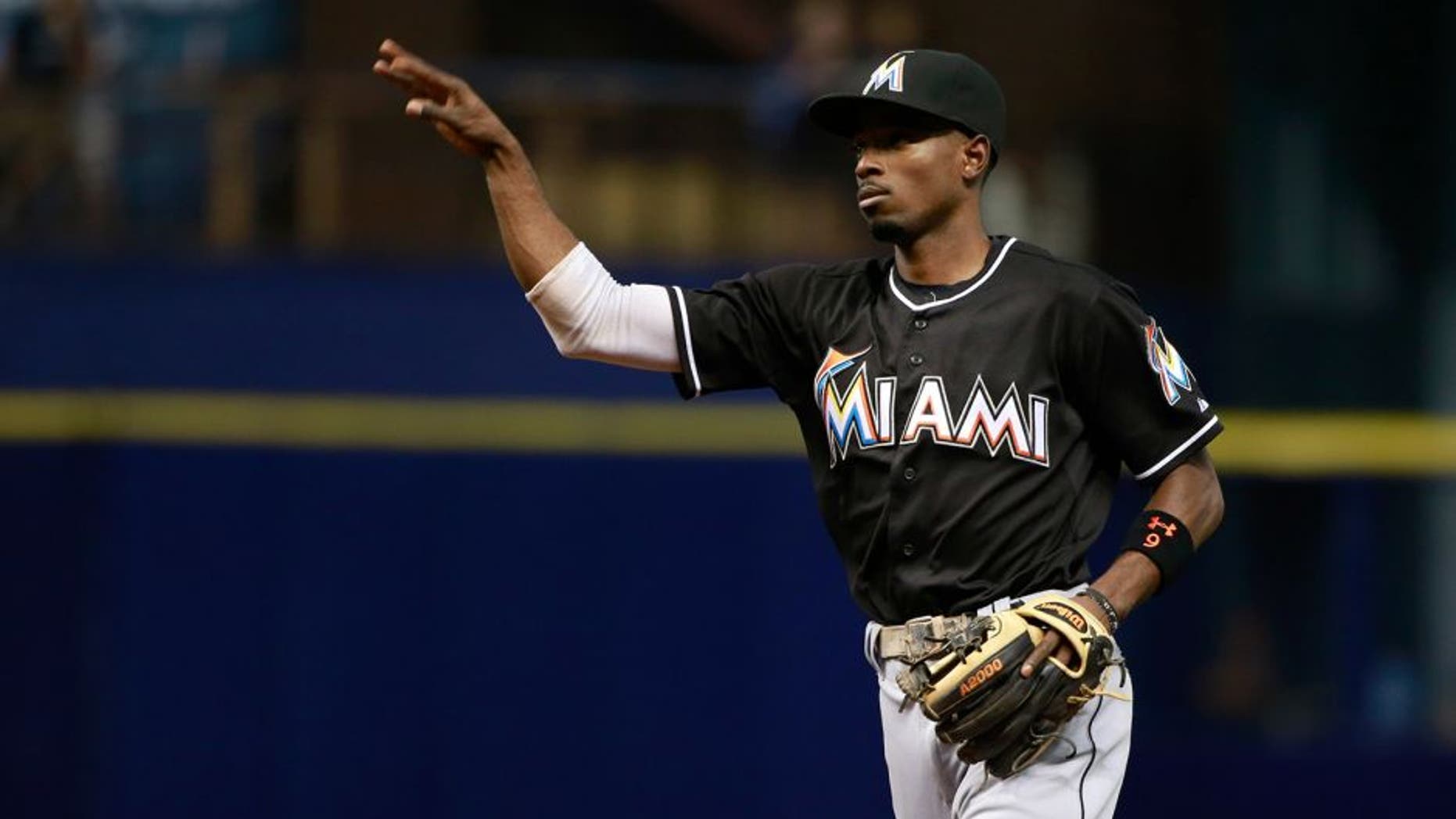 Sep 29, 2015; St. Petersburg, FL, USA; Miami Marlins second baseman Dee Gordon (9) throws the ball against the Tampa Bay Rays at Tropicana Field. Mandatory Credit: Kim Klement-USA TODAY Sports
