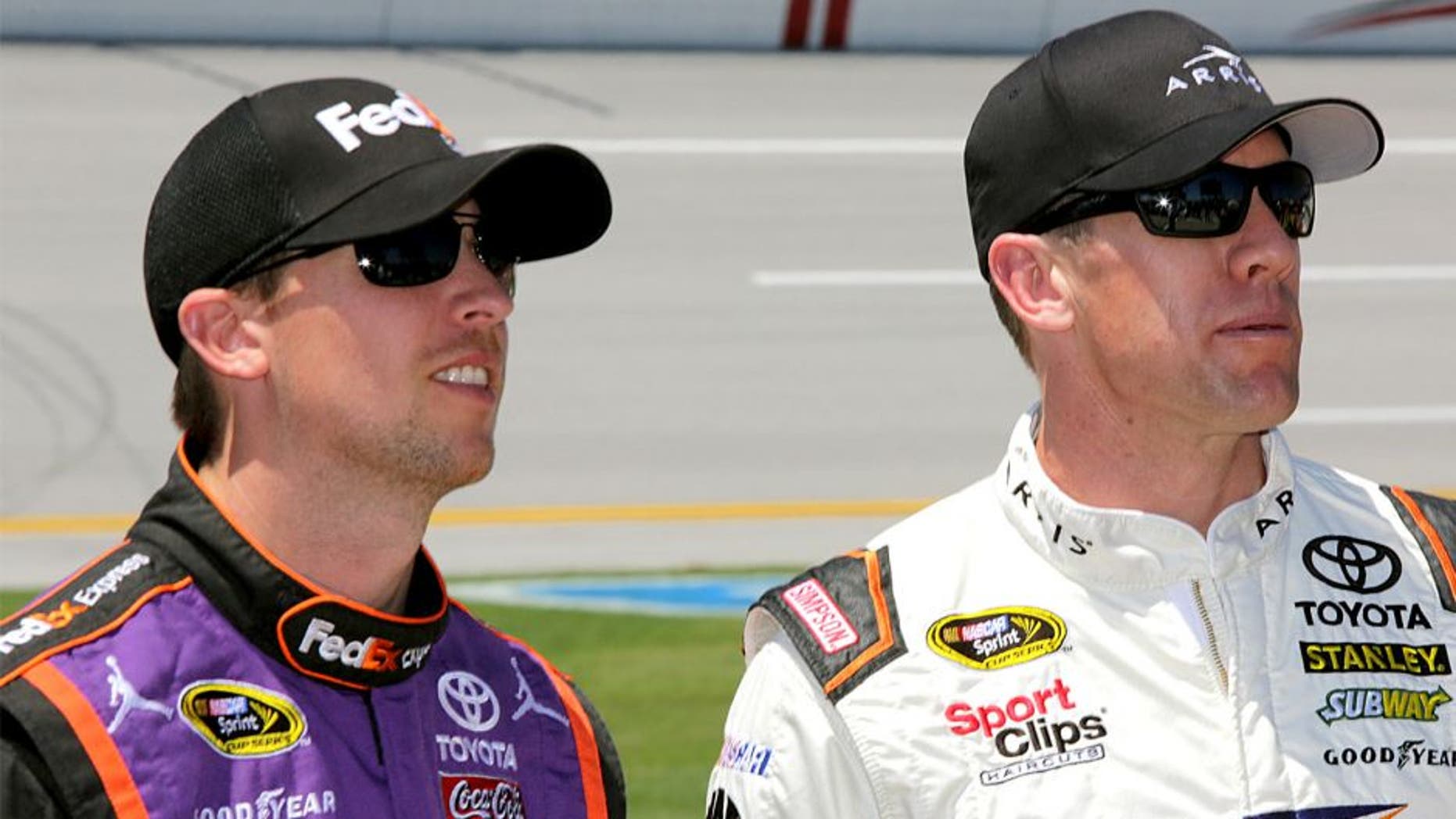 TALLADEGA, AL - MAY 02: Denny Hamlin, driver of the #11 FedEx Express Toyota, talks to Carl Edwards, driver of the #19 ARRIS Toyota, on the grid during qualifying for the NASCAR Sprint Cup Series GEICO 500 at Talladega Superspeedway on May 2, 2015 in Talladega, Alabama. (Photo by Jerry Markland/Getty Images)