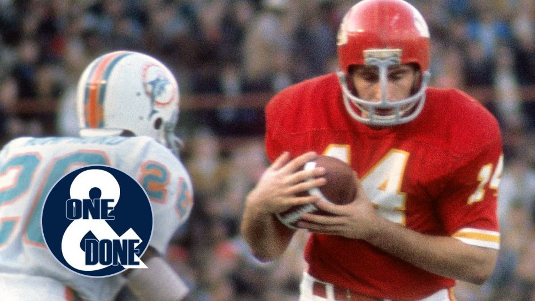 KANSAS CITY, MO - CIRCA 1972: Running Back Ed Podolak #14 of the Kansas City Chiefs running with the ball looks to get pass defensive back Lloyd Mumphord #26 of the Miami Dolphins during an NFL football game at Arrowhead Stadium in Kansas City, Missouri. Podolak played for the Chiefs from 1969-77. (Photo by Focus on Sport/Getty Images)