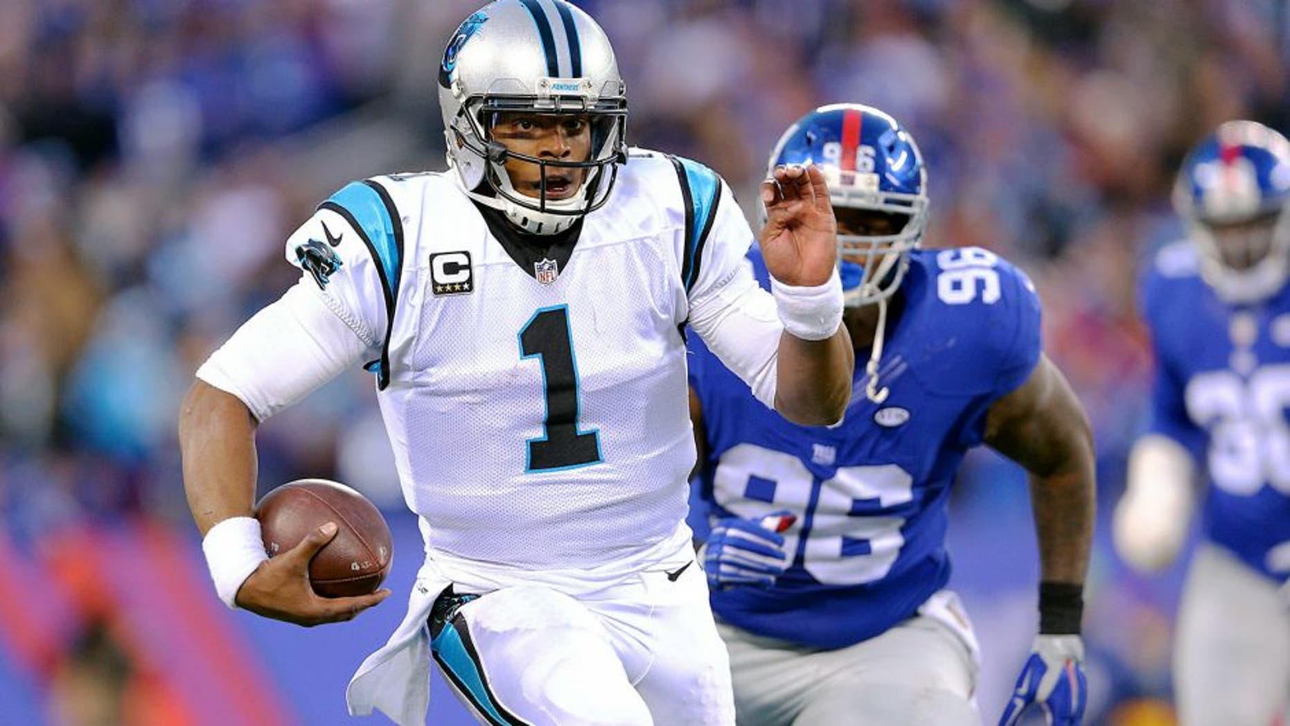 Dec 20, 2015; East Rutherford, NJ, USA; Carolina Panthers quarterback Cam Newton (1) runs with the ball against the New York Giants during the fourth quarter at MetLife Stadium. The Panthers defeated the Giants 38-35. Mandatory Credit: Brad Penner-USA TODAY Sports