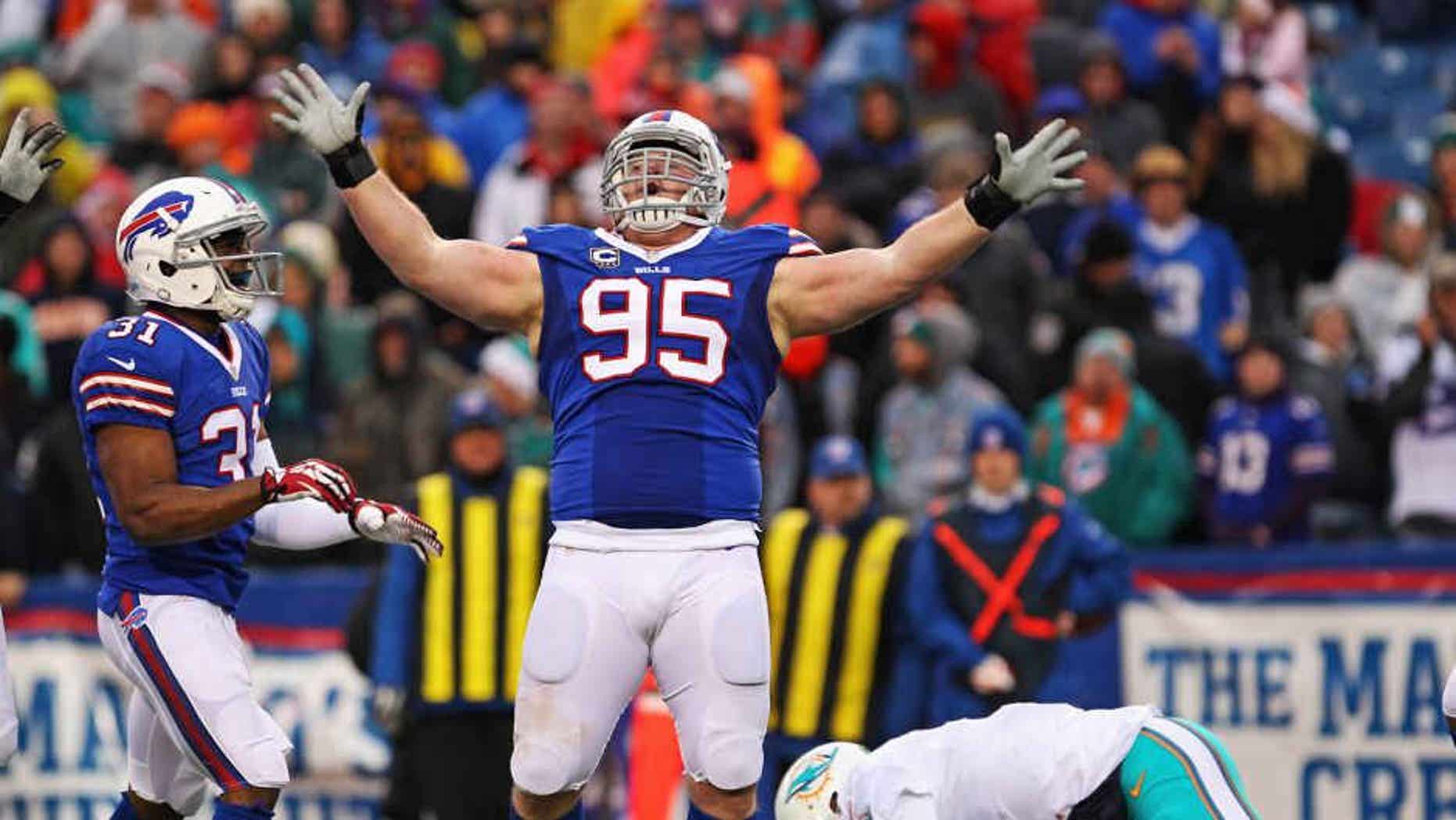 Dec 22, 2013; Orchard Park, NY, USA; Buffalo Bills defensive tackle Kyle Williams (95) celebrates a sack on Miami Dolphins quarterback Ryan Tannehill (17) during the second half at Ralph Wilson Stadium. Buffalo beats Miami 19-0. Mandatory Credit: Timothy T. Ludwig-USA TODAY Sports
