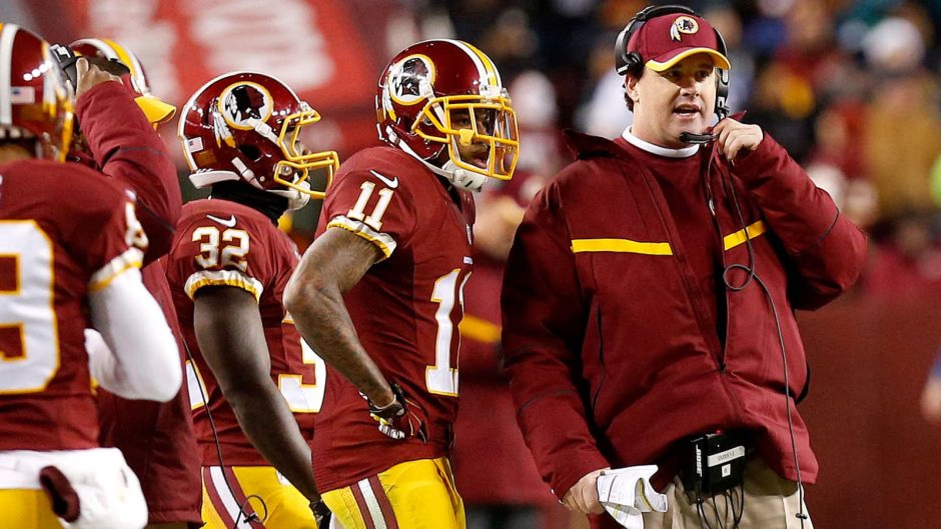 Dec 20, 2014; Landover, MD, USA; Washington Redskins head coach Jay Gruden (R) talks to Redskins wide receiver DeSean Jackson (11) on the sidelines against the Philadelphia Eagles in the fourth quarter at FedEx Field. The Redskins won 27-24. Mandatory Credit: Geoff Burke-USA TODAY Sports