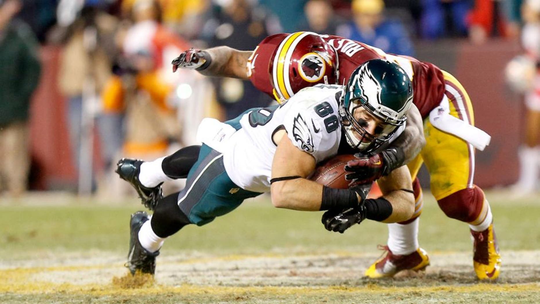 Dec 20, 2014; Landover, MD, USA; Philadelphia Eagles tight end Zach Ertz (86) catches the ball as Washington Redskins inside linebacker Perry Riley (56) tackles the fourth quarter at FedEx Field. The Redskins won 27-24. Mandatory Credit: Geoff Burke-USA TODAY Sports