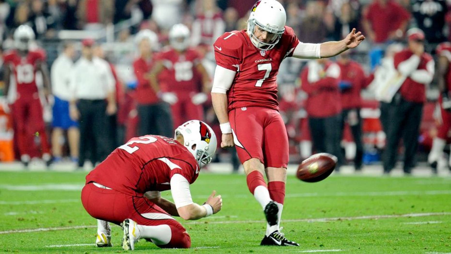 Dec 21, 2014; Glendale, AZ, USA; Arizona Cardinals kicker Chandler Catanzaro (7) kicks a field goal against the Seattle Seahawks during the first half at University of Phoenix Stadium. Mandatory Credit: Joe Camporeale-USA TODAY Sports
