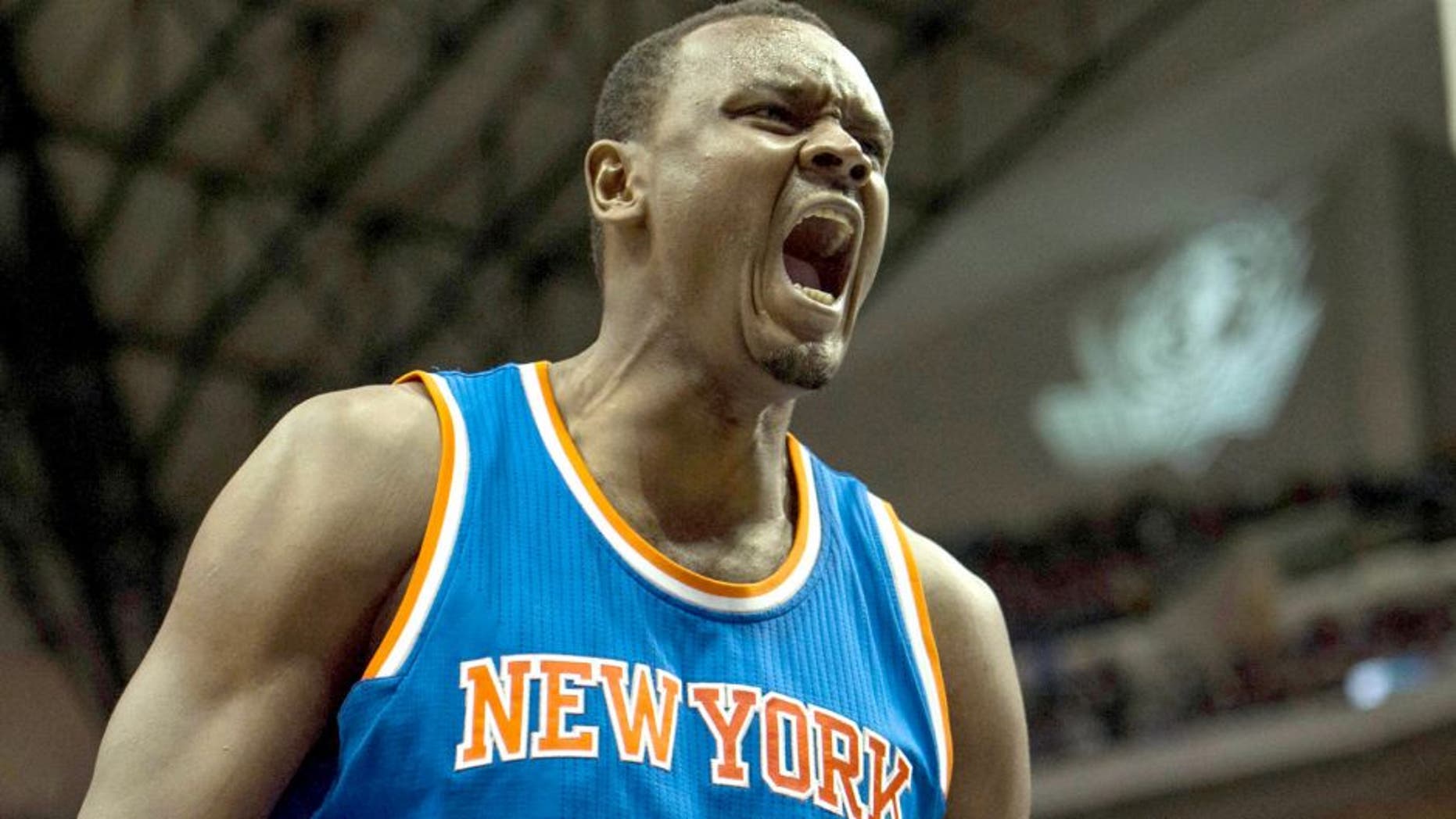 Nov 26, 2014; Dallas, TX, USA; New York Knicks center Samuel Dalembert (11) yells during the second half against the Dallas Mavericks at the American Airlines Center. The Mavericks defeat the Knicks 109-102 in overtime. Mandatory Credit: Jerome Miron-USA TODAY Sports