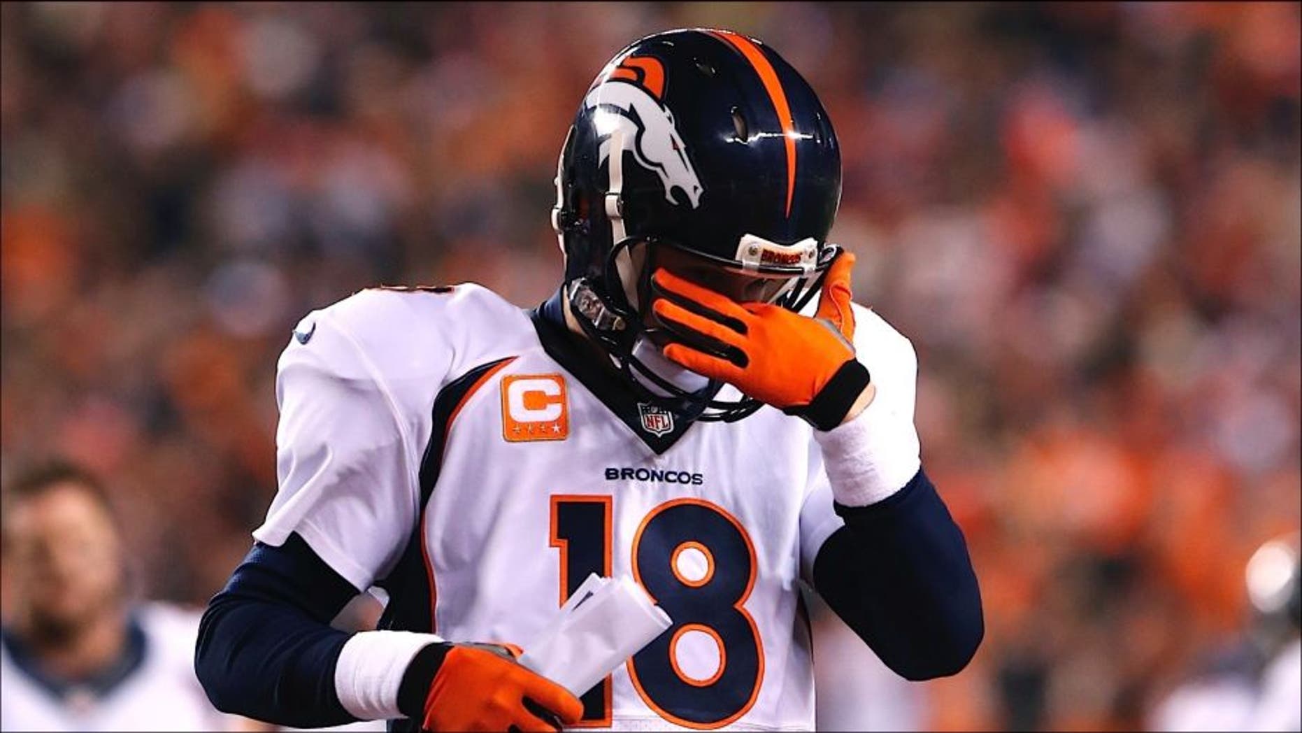 Dec 22, 2014; Cincinnati, OH, USA; Denver Broncos quarterback Peyton Manning (18) walks off the field at halftime against the Cincinnati Bengals at Paul Brown Stadium. Mandatory Credit: Aaron Doster-USA TODAY Sports