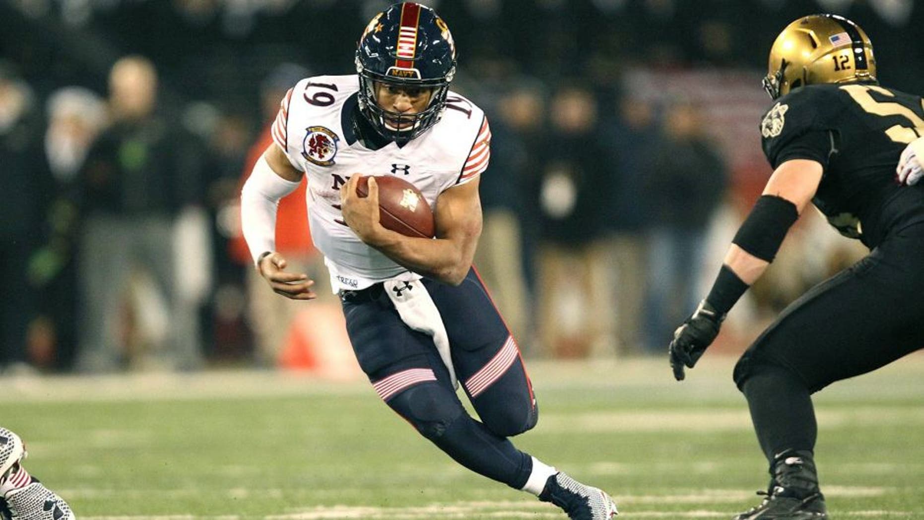 Dec 13, 2014; Baltimore, MD, USA; Navy Midshipmen quarterback Keenan Reynolds (19) rushes the ball against the Army Black Knights during the second half at M&T Bank Stadium. Mandatory Credit: Danny Wild-USA TODAY Sports