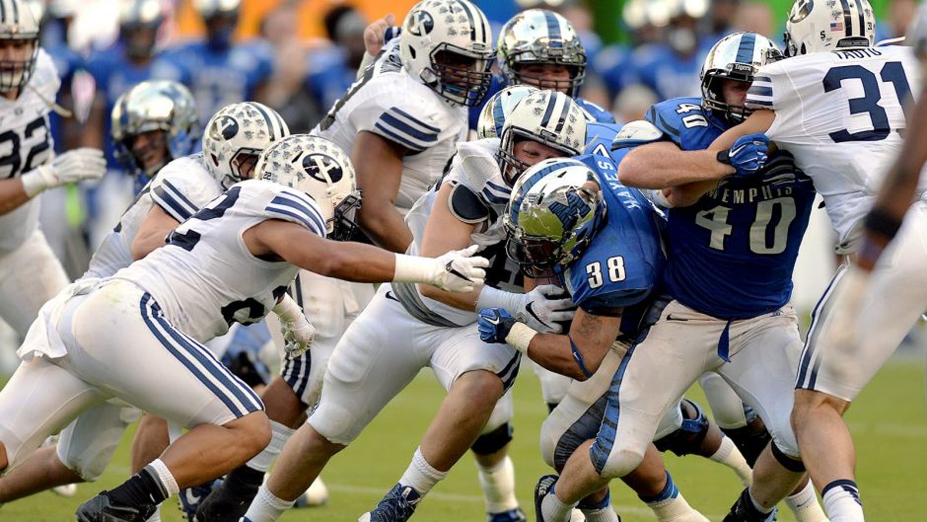 Dec 22, 2014; Miami, FL, USA; Memphis Tigers running back Brandon Hayes (38) is tackled by Brigham Young Cougars defense during the third quarter in the Miami Beach Bowl at Marlins Park. Memphis won 55-48 in a double overtime. Mandatory Credit: Steve Mitchell-USA TODAY Sports