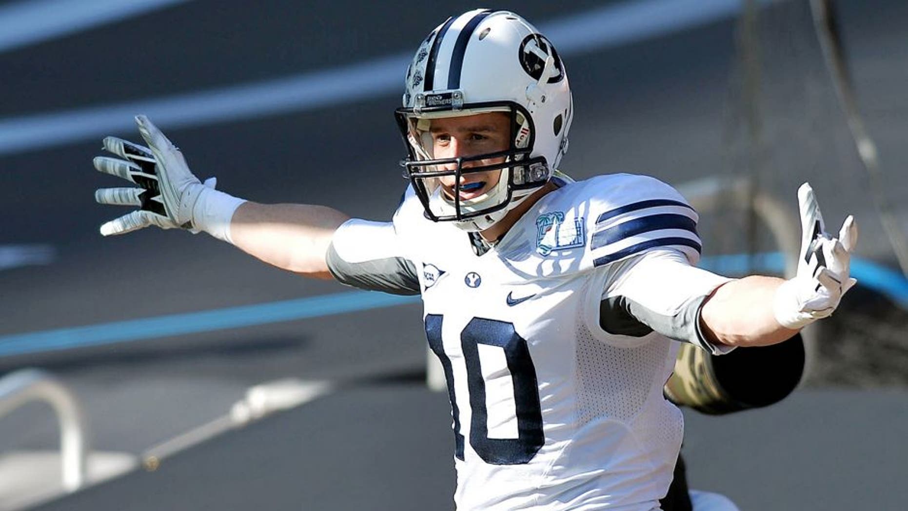 Dec 22, 2014; Miami, FL, USA; Brigham Young Cougars wide receiver Mitch Mathews (10) celebrates his touchdown against Memphis Tigers during the first quarter in the Miami Beach Bowl at Marlins Park. Mandatory Credit: Steve Mitchell-USA TODAY Sports
