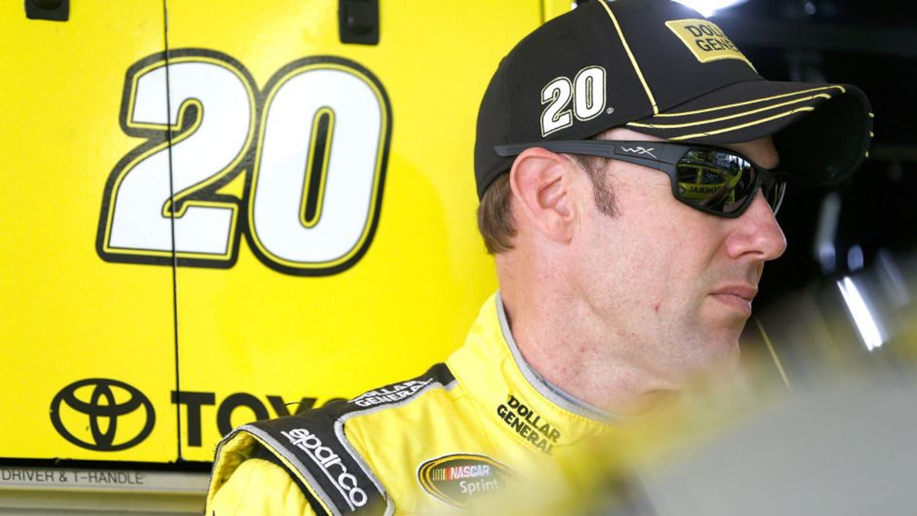 HOMESTEAD, FL - NOVEMBER 20: Matt Kenseth, driver of the #20 Dollar General Toyota, stands in the garage area during practice for the NASCAR Sprint Cup Series Ford EcoBoost 400 at Homestead-Miami Speedway on November 20, 2015 in Homestead, Florida. (Photo by Brian Lawdermilk/Getty Images)