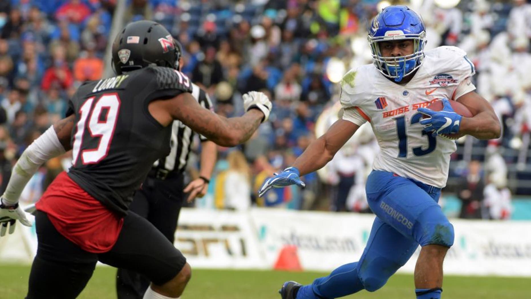 Dec 23, 2015; San Diego, CA, USA; Boise State Broncos running back Jeremy McNichols (13) is pursued by Northern Illinois Huskies cornerback Shawun Lurry (19) in the 2015 Poinsettia Bowl at Qualcomm Stadium. Mandatory Credit: Kirby Lee-USA TODAY Sports