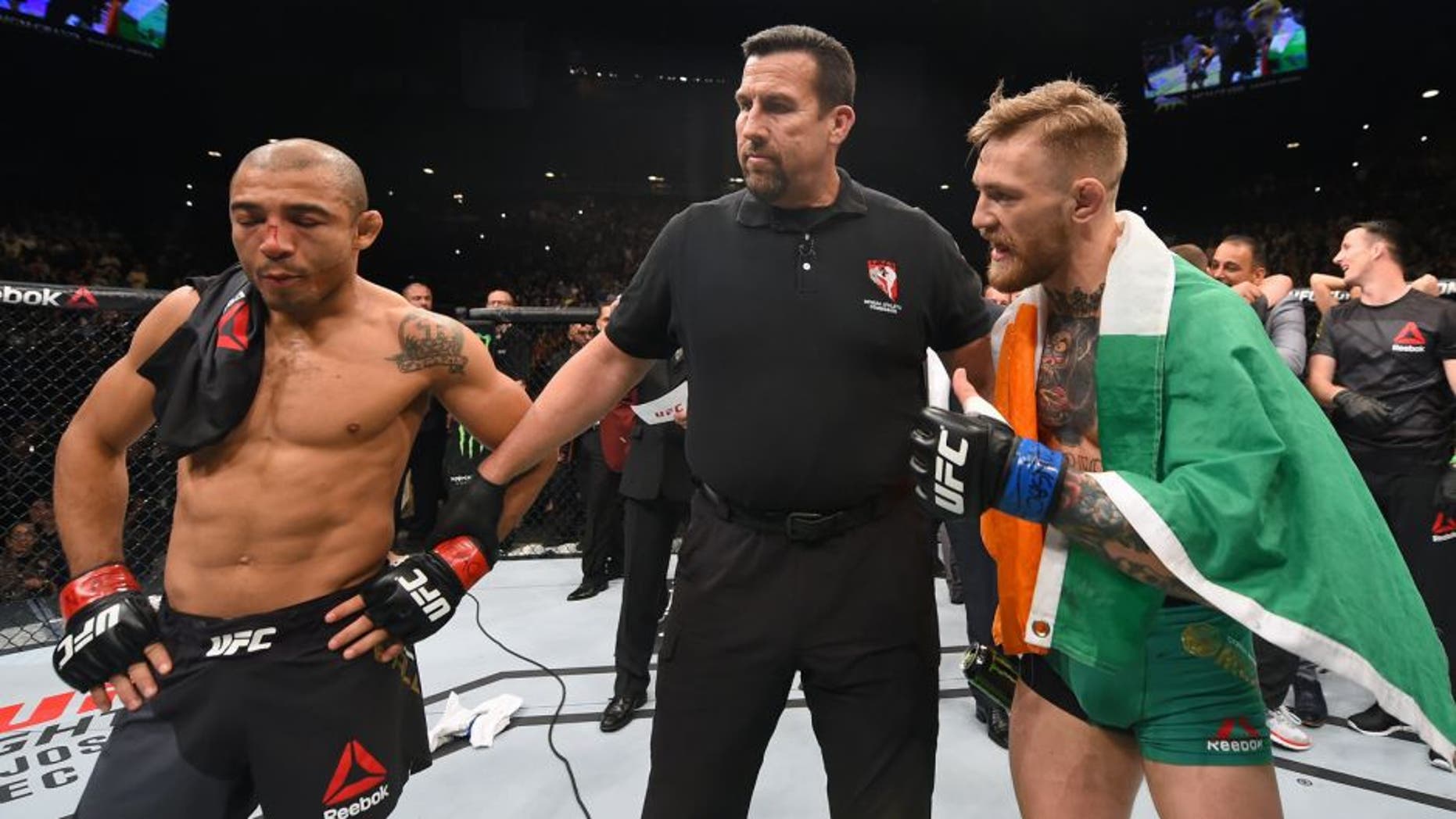LAS VEGAS, NV - DECEMBER 12: Jose Aldo of Brazil (left) and Conor McGregor of Ireland (right) await the final decision in their UFC featherweight championship bout during the UFC 194 event inside MGM Grand Garden Arena on December 12, 2015 in Las Vegas, Nevada. (Photo by Josh Hedges/Zuffa LLC/Zuffa LLC via Getty Images)