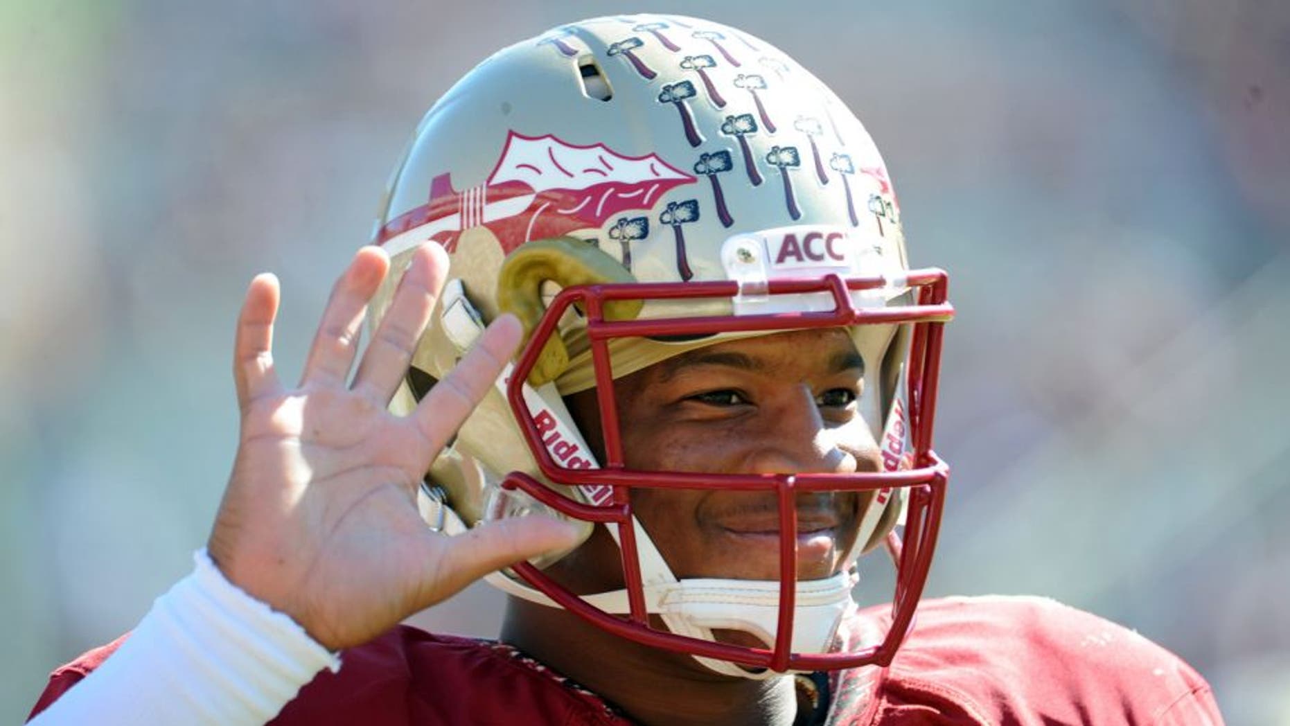 Oct 26, 2013; Tallahassee, FL, USA; Florida State Seminoles quarterback Jameis Winston (5) warms up before the start of the game against the North Carolina State Wolfpack at Doak Campbell Stadium. Mandatory Credit: Melina Vastola-USA TODAY Sports